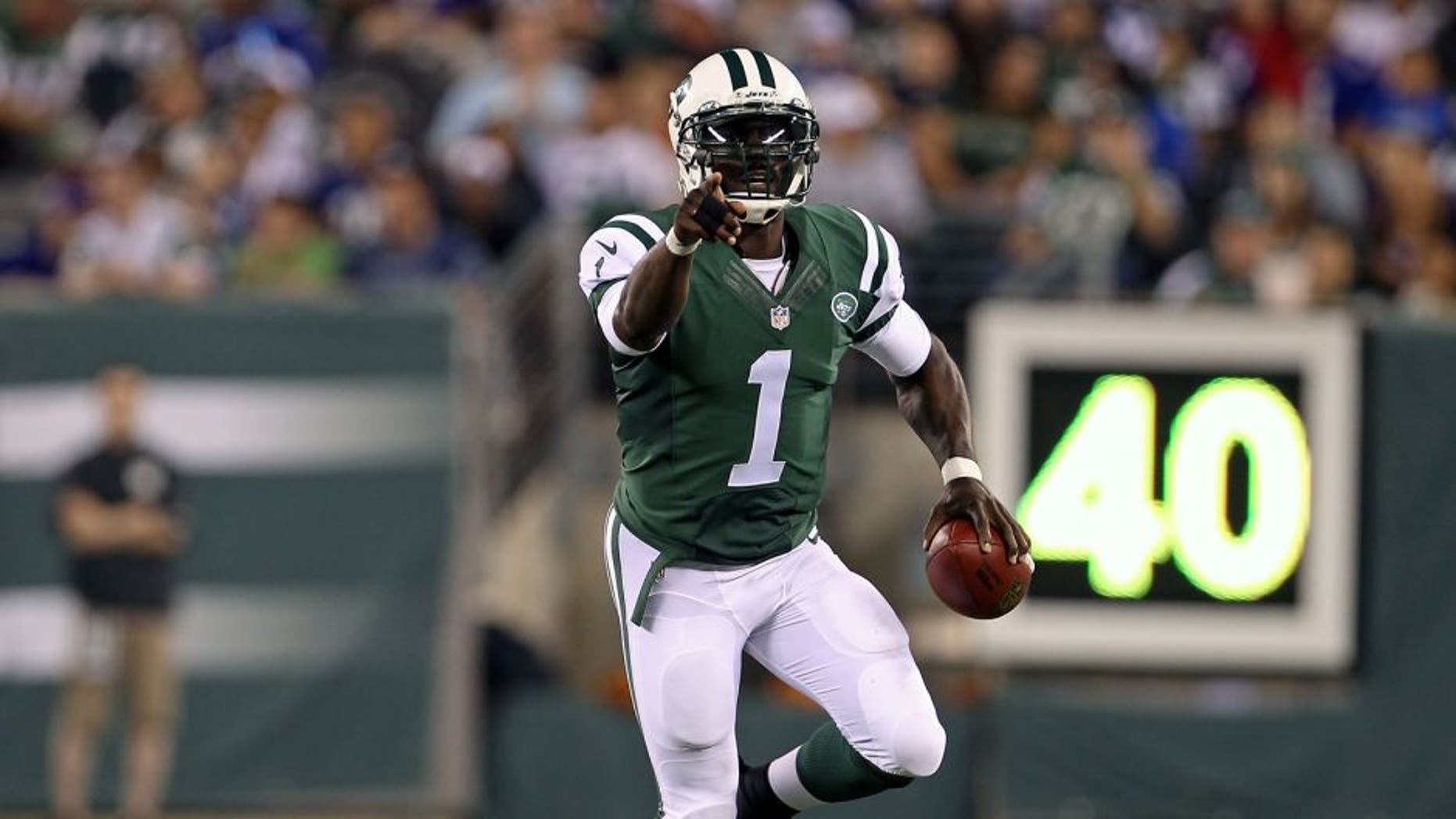 Aug 22, 2014; East Rutherford, NJ, USA; New York Jets quarterback Michael Vick (1) scrambles against the New York Giants during the second half at MetLife Stadium. The Giants defeated the Jets 35-24. Mandatory Credit: Adam Hunger-USA TODAY Sports