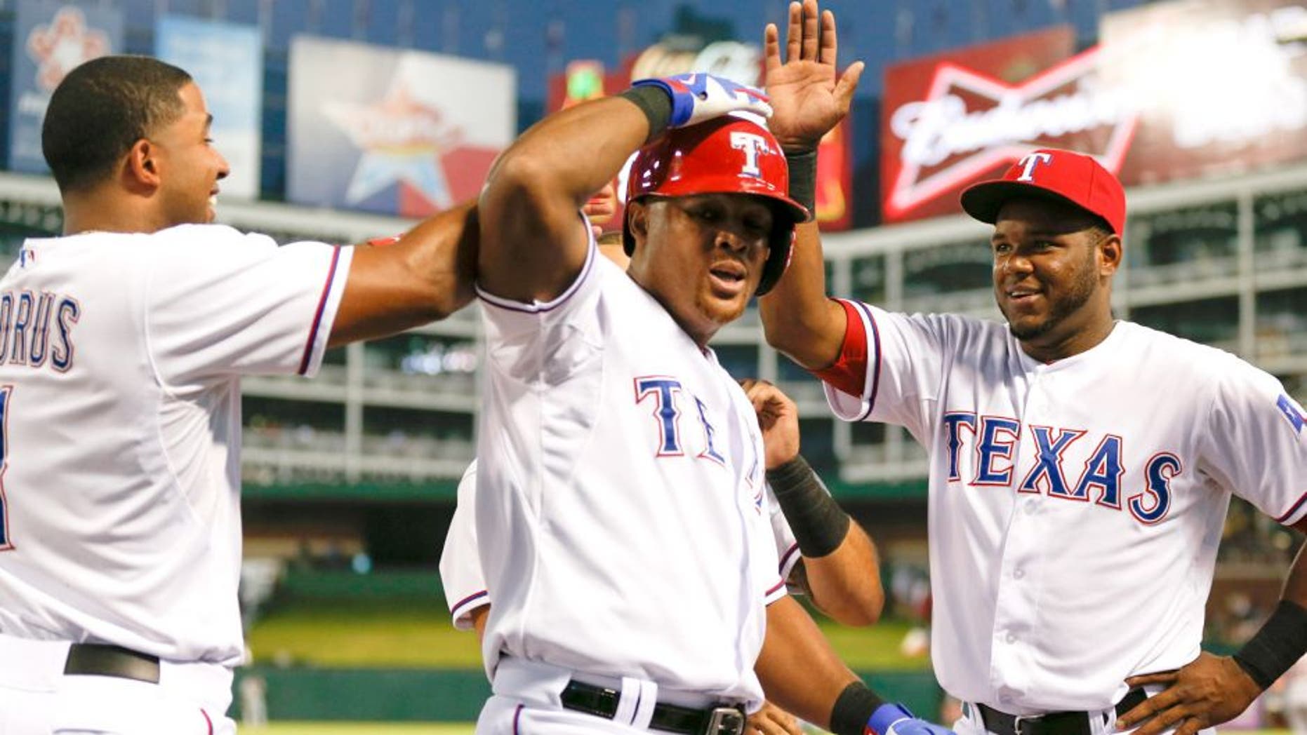 The Texas Rangers' Adrian Beltre, center, celebrates his two-run home run with Elvis Andrus, left, and Hanser Alberto against the Detroit Tigers during the first inning on Wednesday, Sept. 30, 2015, at Globe Life Park in Arlington, Texas. (Jim Cowsert/Fort Worth Star-Telegram/TNS via Getty Images)