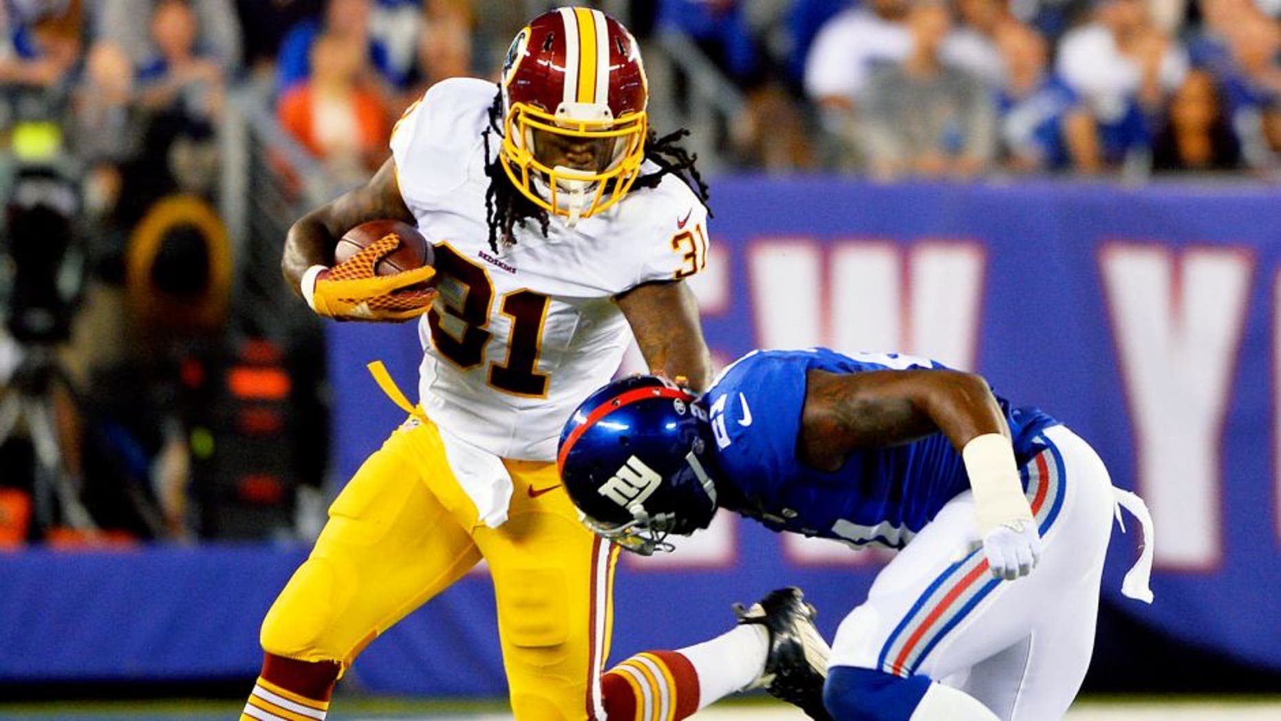 EAST RUTHERFORD, NJ - SEPTEMBER 24: Matt Jones #31 of the Washington Redskins tries to avoid the tackle of Landon Collins #21 of the New York Giants in the second quarter at MetLife Stadium on September 24, 2015 in East Rutherford, New Jersey. (Photo by Alex Goodlett/Getty Images)