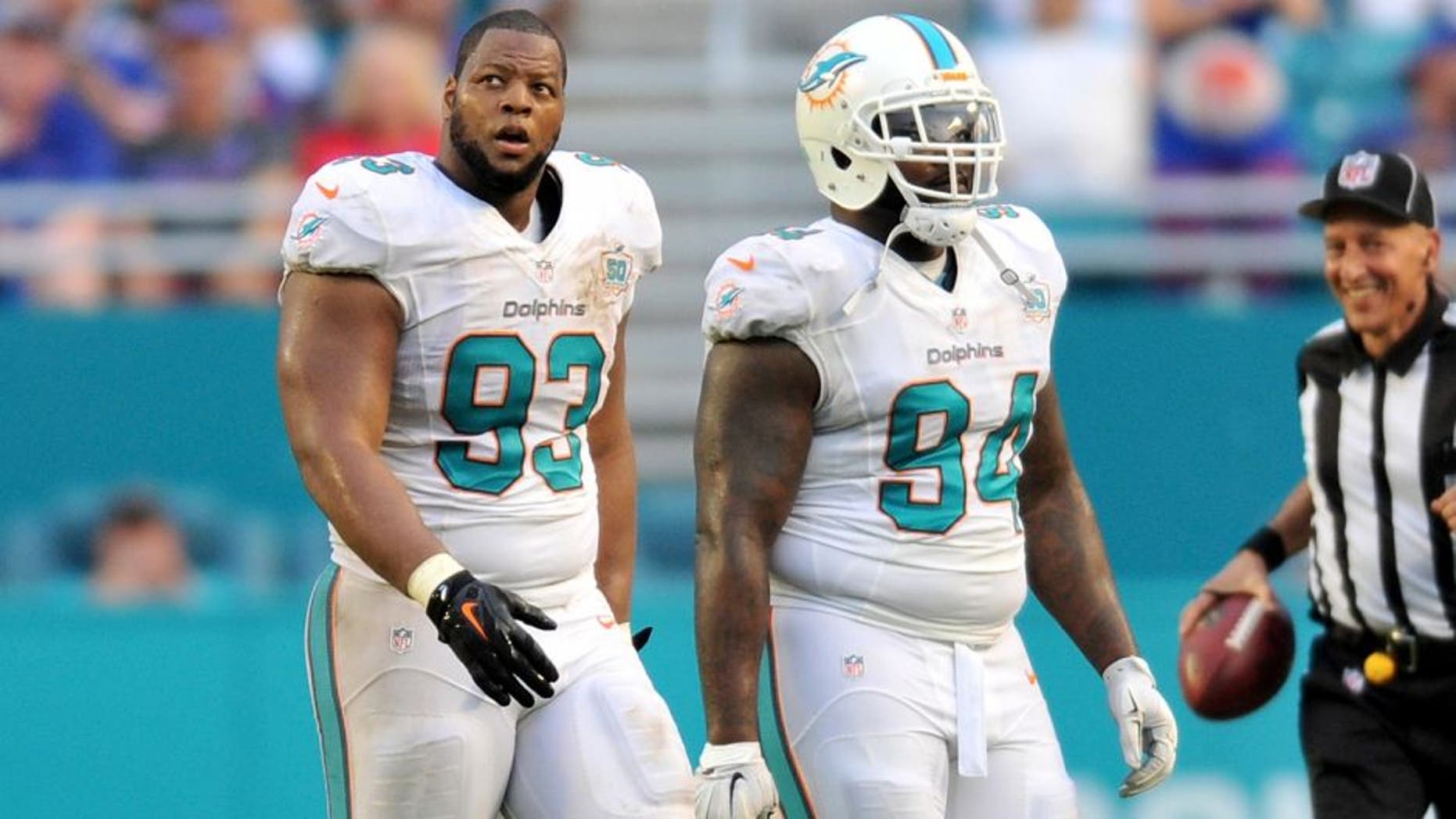 Sep 27, 2015; Miami Gardens, FL, USA; Miami Dolphins defensive tackle Ndamukong Suh (left) walks off the field with Dolphins defensive tackle C.J. Mosley (right) during the second half against the Buffalo Bills at Sun Life Stadium. Mandatory Credit: Steve Mitchell-USA TODAY Sports