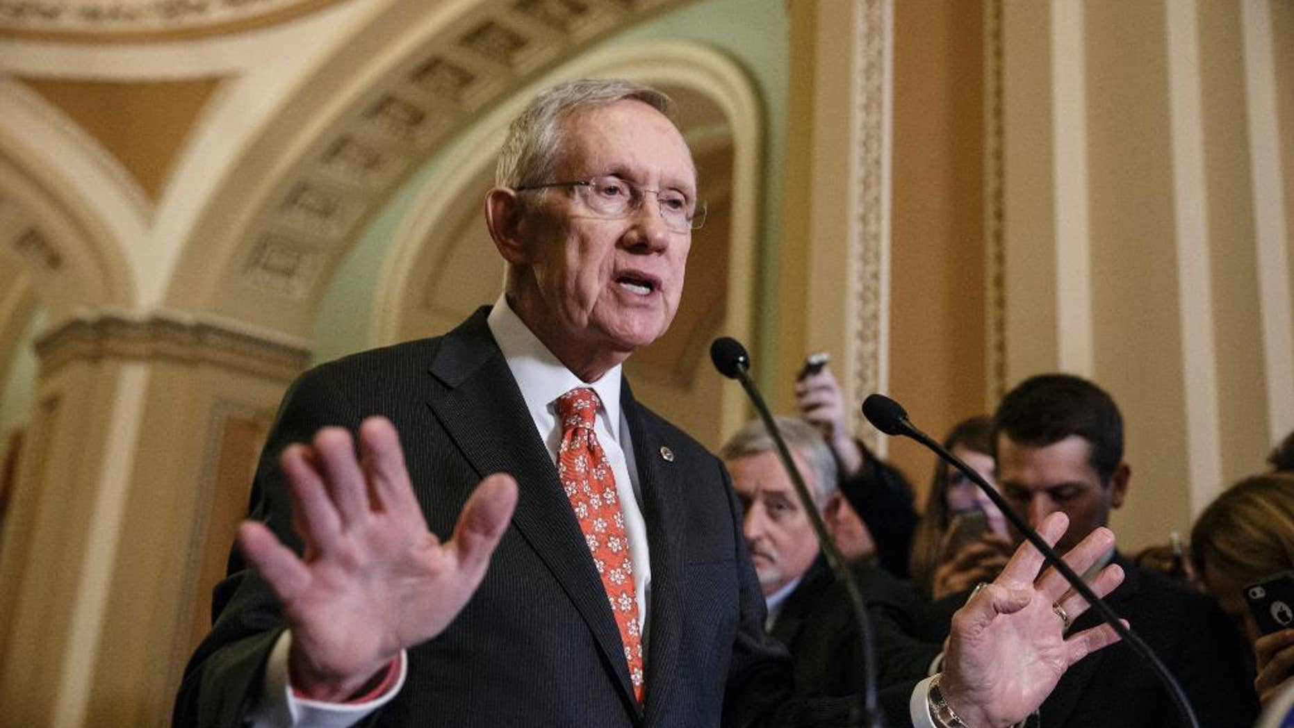 FILE - In this Dec. 2, 2014, file photo, Senate Majority Leader Harry Reid, D-Nev., speaks with reporters on Capitol Hill in Washington. Reid has returned to the Capitol after missing the first two weeks of the new session with major injuries from an exercise accident. The Senate's top Democrat has broken bones in his face and fractured ribs suffered when a piece of exercise equipment broke and sent him barreling into cabinets at his new home in Nevada. (AP Photo/J. Scott Applewhite, File)