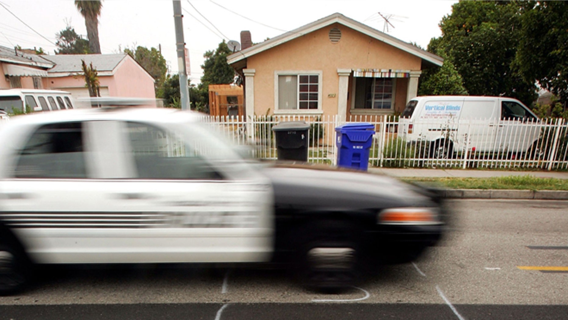 MAYWOOD, CA - MAY 17: A police car drives down a residential street marked to be dug up for service with shorthand letters for "underground service alert" on May 17, 2006 in the Los Angeles-area city of Maywood, California. According to reports, the Maywood City Council has declared the municipality a "sanctuary" for illegal immigrants. The city has done away with the police department's traffic division after receiving complaints that officers were targeting illegal immigrants which has made it more difficult for police to tow cars whose owners do not have driver's licenses. The city also officially opposed a proposed federal law that would have criminalized illegal immigration and forced local police to enforce immigration law. Approximately 96 percent of the city's population of about 29,000 is Latino and more than half are foreign-born. (Photo by David McNew/Getty Images)