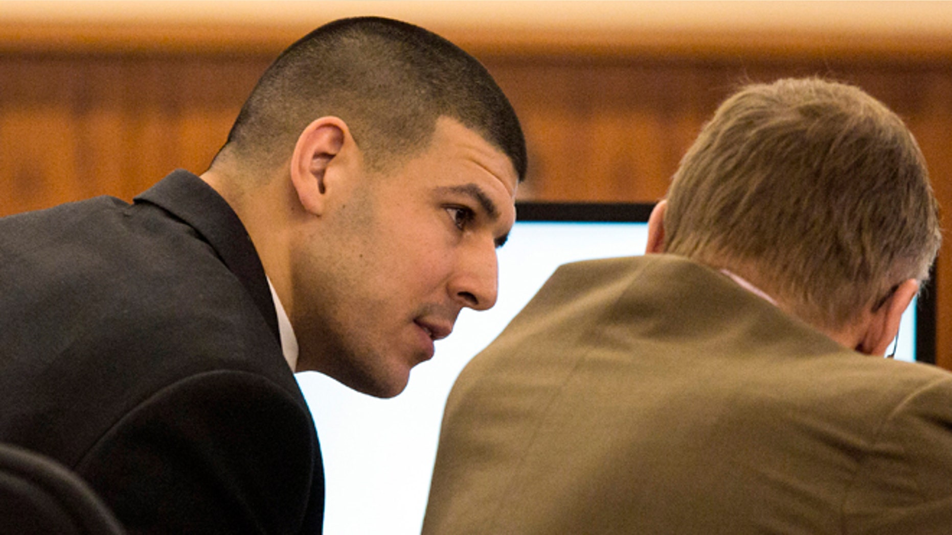 Former New England Patriots NFL football player Aaron Hernandez consults with his attorney Charles Rankin during his murder trial at Bristol County Superior Court, Wednesday, March 4, 2015, in Fall River, Mass. Hernandez is accused of the June 2013 killing of Odin Lloyd. (AP Photo/Dominick Reuter, Pool)