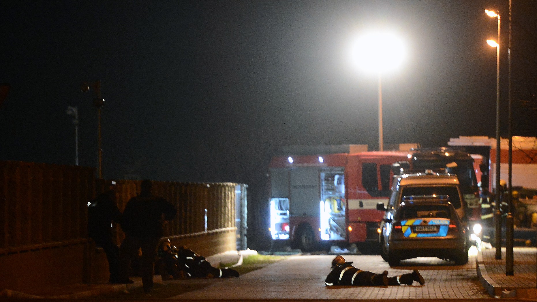 Firemen lay on the ground near the residence of Palestinian ambassador to the Czech Republic, Jamel al-Jamal, in Prague on Wednesday, Jan. 1, 2014. The ambassador died in an explosion that occurred when he opened an office safe that officials say had been left untouched for more than 20 years. A Palestinian official says foul play is not suspected in today's death of the Palestinian ambassador to the Czech Republic. (AP Photo / CTK, Katerina Sulova) SLOVAKIA OUT