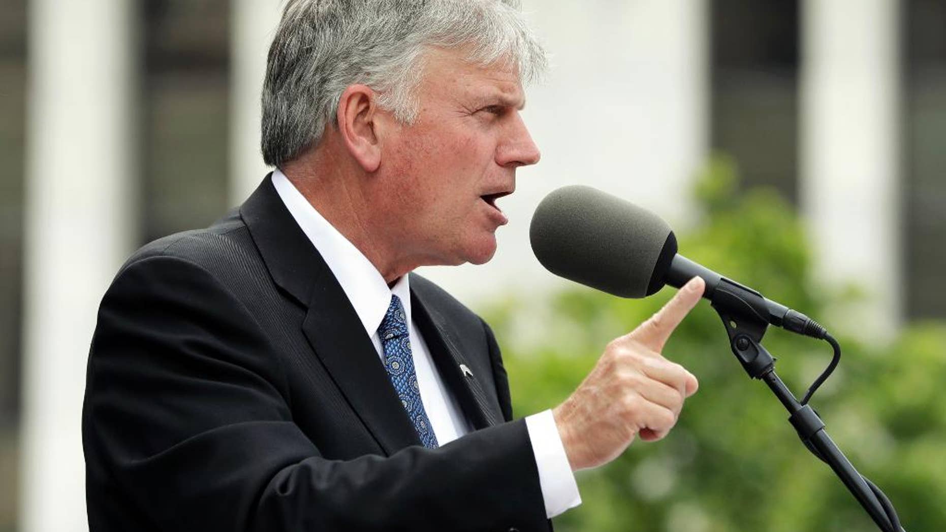 FILE - In this Thursday, Aug. 25, 2016 file photo, the Rev. Franklin Graham speaks during an election prayer rally outside the state Capitol in Albany, N.Y. Graham is scheduled to hold a mass prayer rally as part of a 50-state tour to urge evangelicals to vote, Tuesday, Aug. 30, 2016, on Boston Common. (AP Photo/Mike Groll, File)