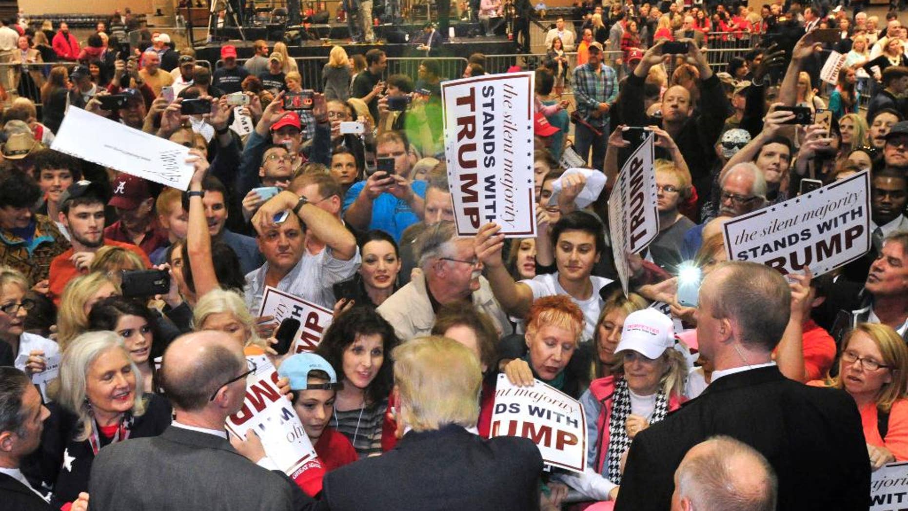FILE - In this Nov. 21, 2015, file photo, the crowd surges to greet Republican presidential candidate Donald Trump after he spoke in Birmingham, Ala. In less than a month, voters will begin casting their ballots in what could turn out to be a bitter, months-long fight for the Republican nomination. (AP Photo/Eric Schultz, File)