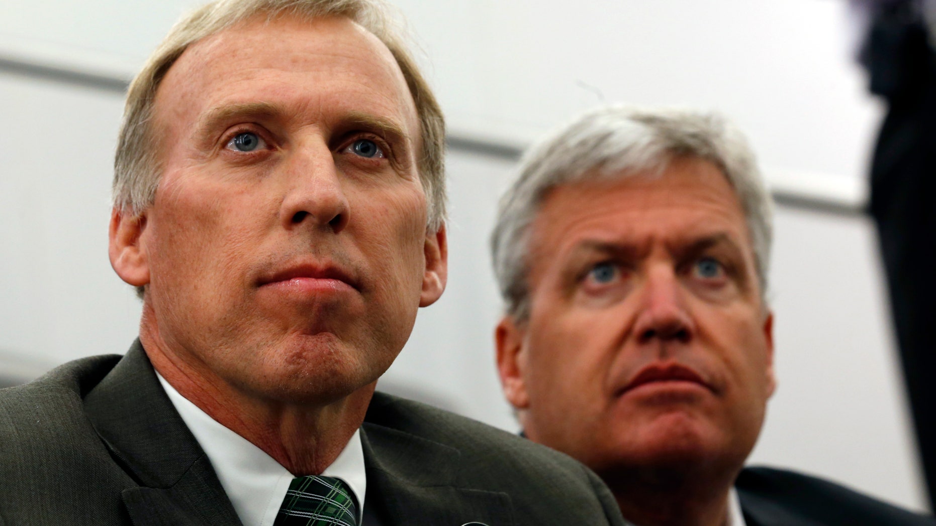 FILE - In this Jan. 24, 2013 file photo, John Idzik, left, sits next to New York Jets head coach Rex Ryan while waiting to be introduced as the Jets new general manager during an NFL football news conference in Florham Park, N.J. Idzik's first headline-making move as the Jets' general manager was trading away his best player. Idzik will now try to find a few guys who can help get the franchise _ which was a win away from the Super Bowl in the 2009 and ’10 seasons _ back on track. (AP Photo/Julio Cortez, File)