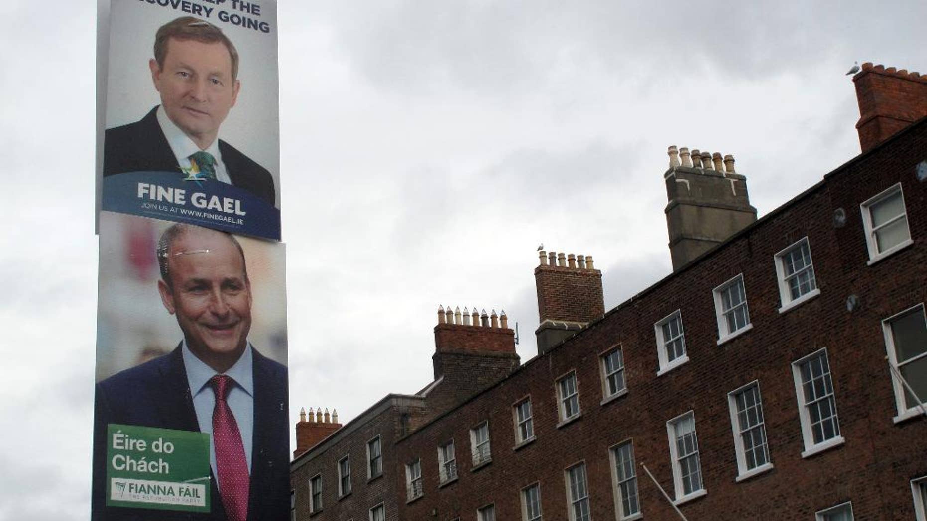FILE - This is a Feb. 5, 2016 file photo, of rival election posters for Fine Gael leader Enda Kenny and Fianna Fail leader Micheal Martin as they adorn a lamp post in Dublin, Ireland. Ireland’s lawmakers have failed for a third time to elect a prime minister. Thursday's, April 14, 2016, stalemate leaves the country in political limbo for a record 48 days following an inconclusive Feb. 26 election.(AP Photo/Shawn Pogatchnik, File)