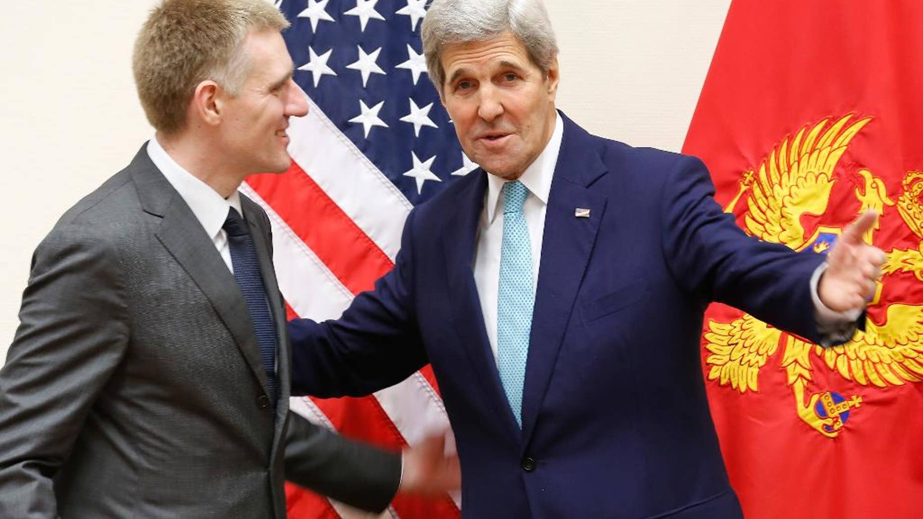 U.S. Secretary of State John Kerry, right, meets Montenegro's Foreign Minister Igor Luksic at the NATO ministerial meetings at NATO Headquarters in Brussels, Wednesday Dec. 2, 2015. Montenegro was welcomed during the meetings as a new NATO member. (Jonathan Ernst / Pool via AP)