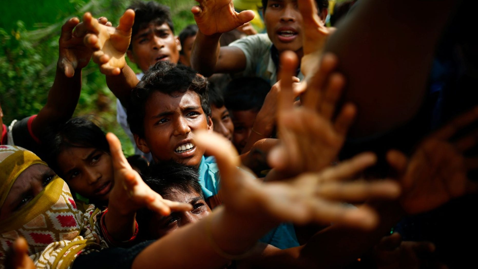 Rohingya refugees stretch their hands for food near Balukhali in Cox’s Bazar, Bangladesh, September 4, 2017.