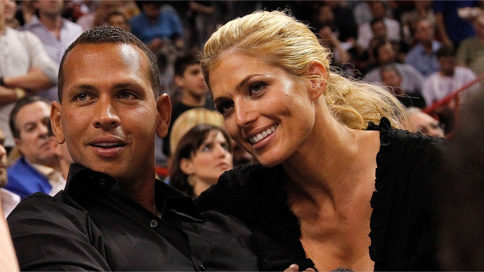 MIAMI, FL - JANUARY 17: Baseball player Alex Rodriguez (L) of the New York Yankees and Torrie Wilson watch a game between the Miami Heat and the San Antonio Spurs at American Airlines Arena on January 17, 2012 in Miami, Florida. NOTE TO USER: User expressly acknowledges and agrees that, by downloading and/or using this Photograph, User is consenting to the terms and conditions of the Getty Images License Agreement. (Photo by Mike Ehrmann/Getty Images)