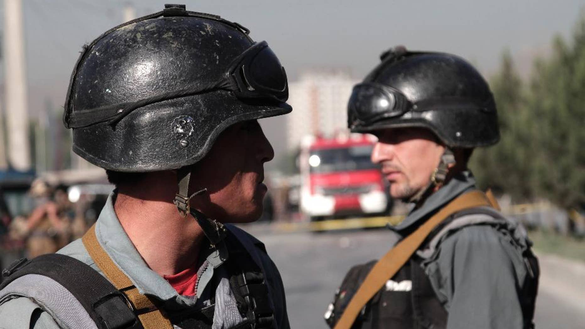 Afghan police soldiers inspect the site of a suicide attack in Kabul, Afghanistan, Monday, June 20, 2016. At least a dozen Nepalese security guards of a foreign logistic company were killed Monday when a Taliban suicide bomber targeted their minibus in the Afghan capital, interior ministry and an Afghan security official said. (AP Photo/Rahmat Gul)