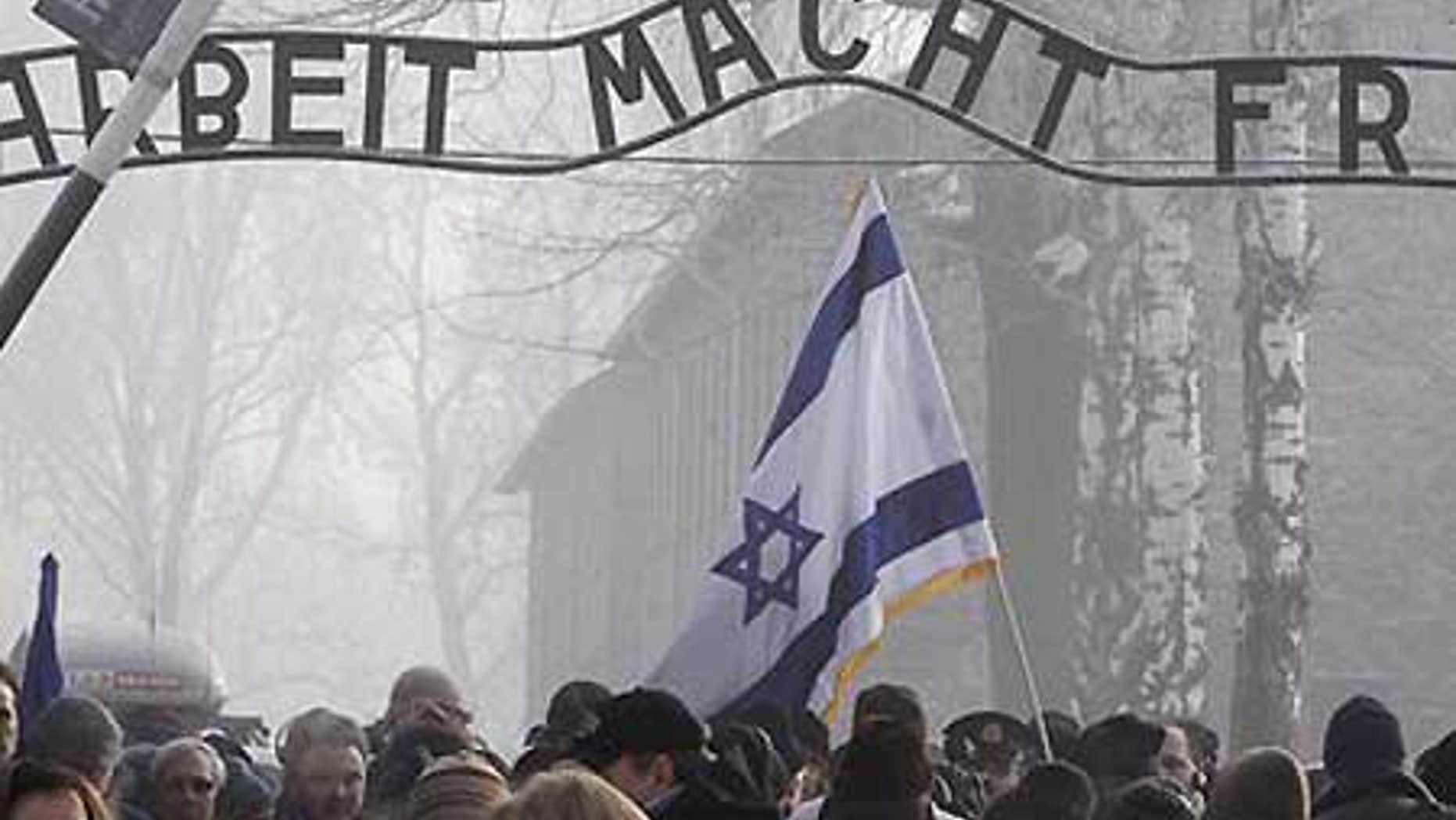 Jan. 27: Visitors under the infamous Arbeit Macht Frei 'Work Sets You Free' sign over the main gate of Auschwitz.