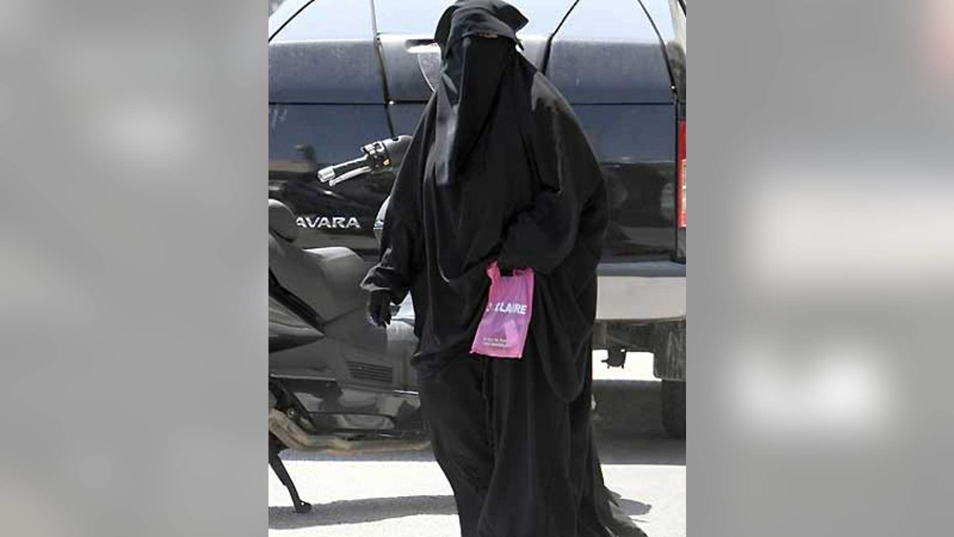 File: An unidentified woman wears Muslim style dress, with only her eyes visible, in Marseille, southern France.
