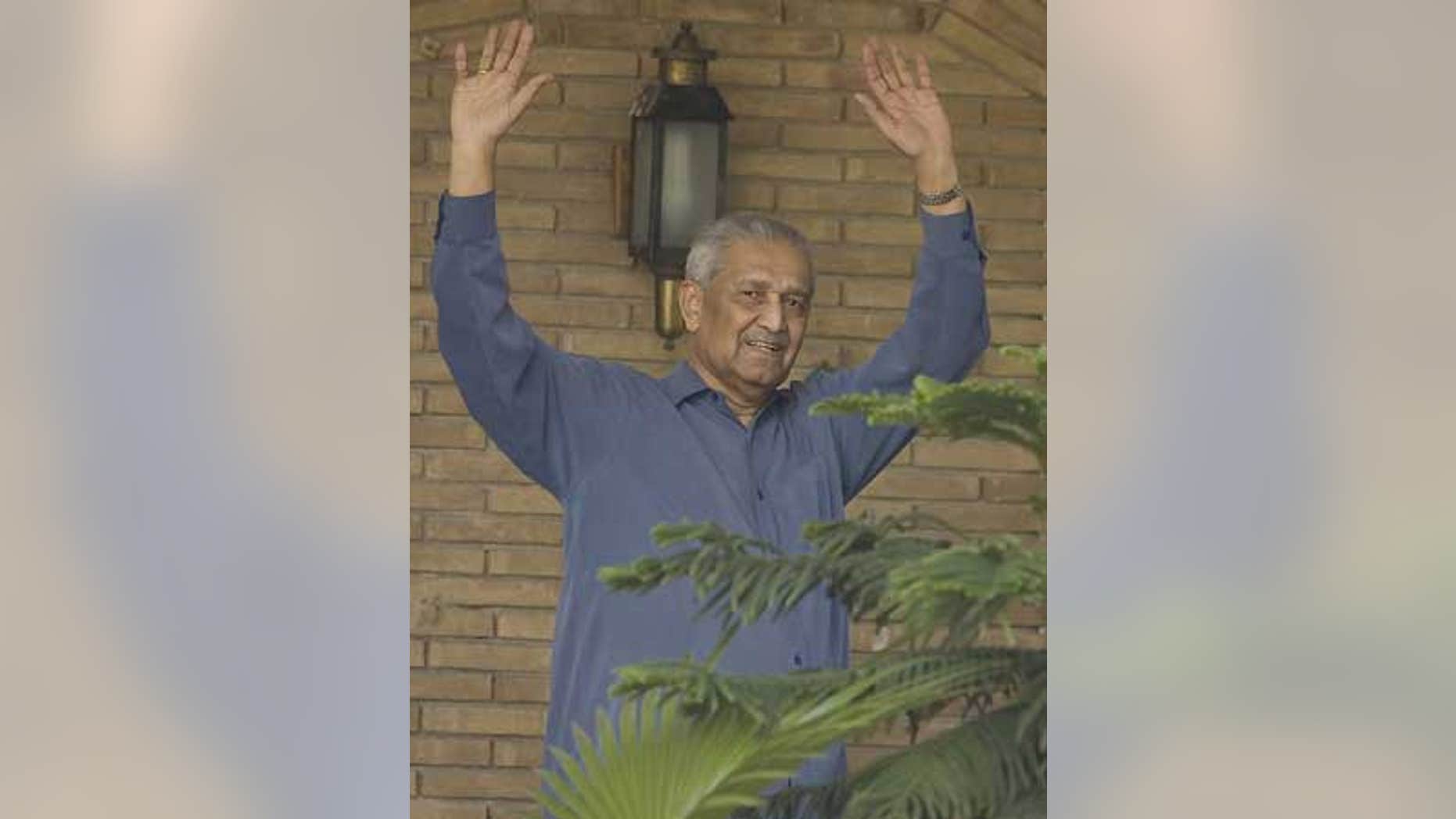 Feb. 6: Disgraced Pakistani nuclear scientist Abdul Qadeer Khan waves to media at his home in Islamabad, Pakistan.