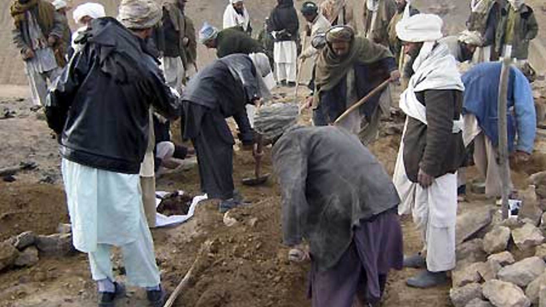 Feb. 17: Afghans dig graves for the victims who villagers said were killed in an airstrike, in Gozara district of Herat province, west of Kabul.