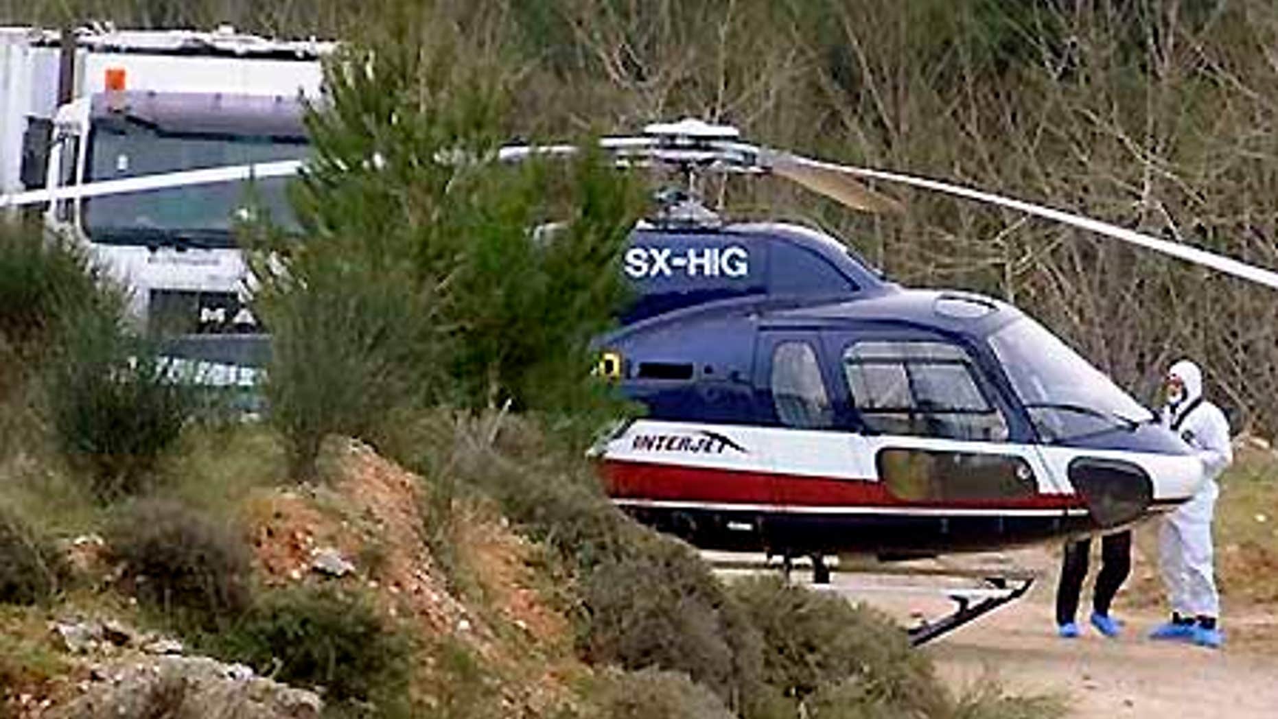 Feb. 22: Forensic experts investigate a helicopter used in the escape of convicts Vassilis Paleokostas and Alket Rizaj from a high-security prison.
