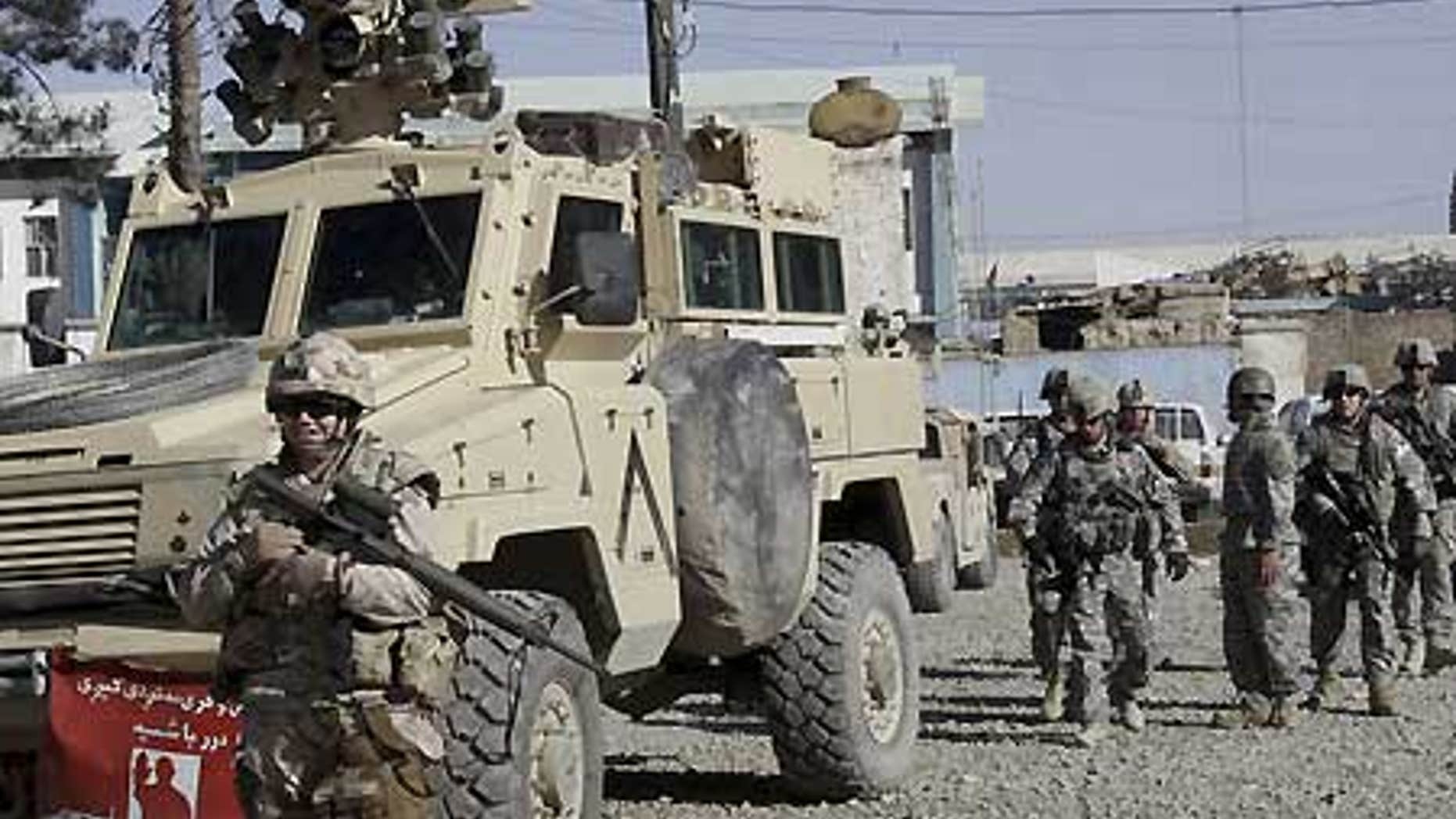 Feb. 15: U.S., Canadian soldiers investigate suspected Taliban militants in Kandahar, Afghanistan.