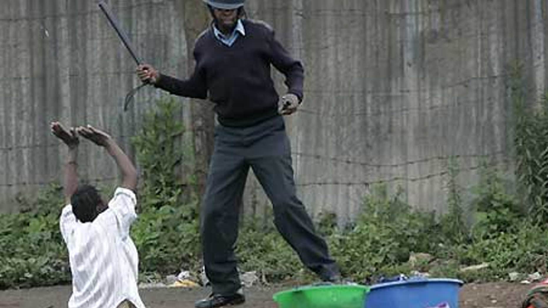 File: A woman who was washing her laundry when police fired tear gas begs a policeman not to beat her in Nairobi slum.