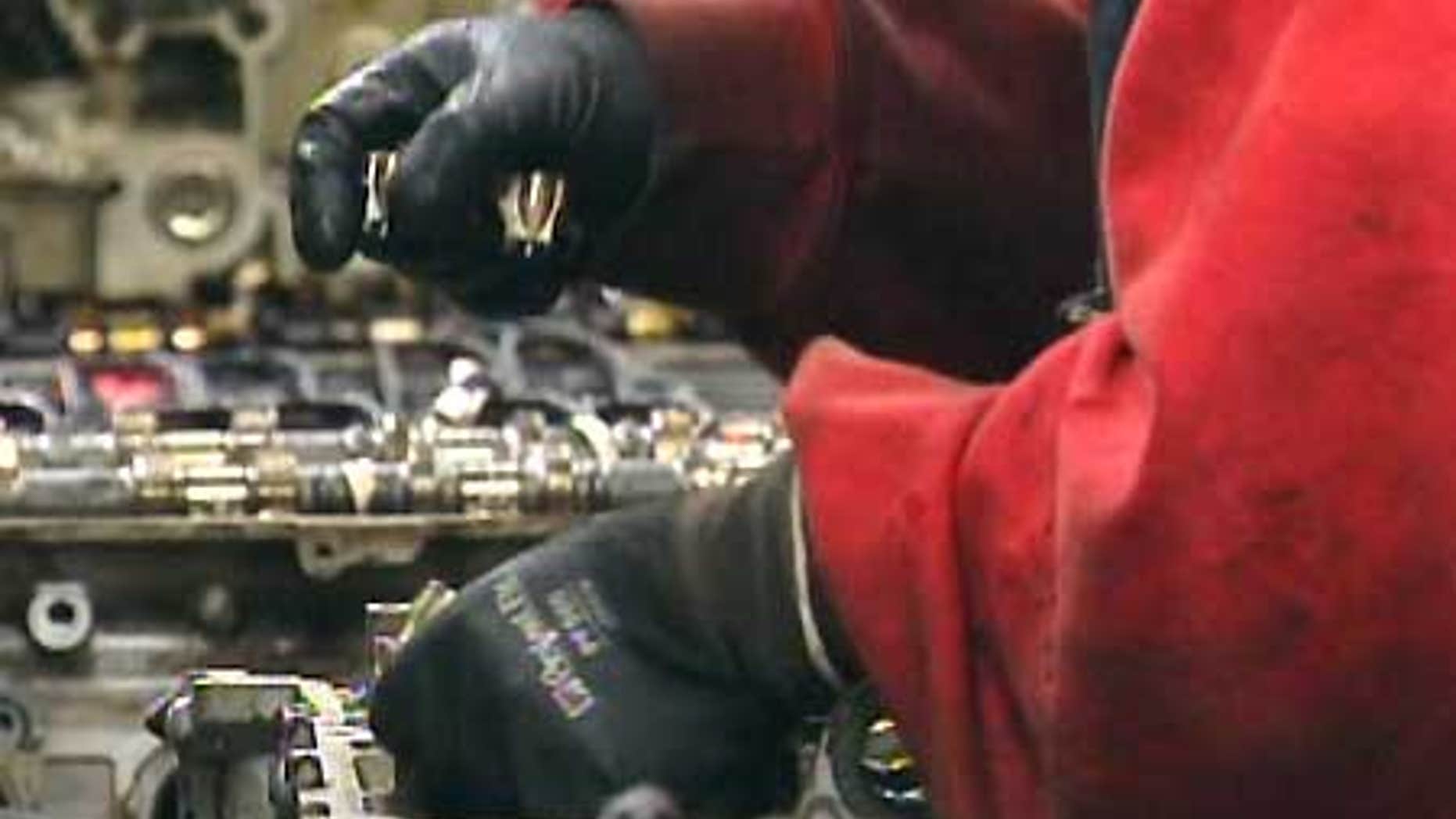 A worker handles parts at a Yamato Engine Specialists plant in Washington where Immigration and Customs Enforcement officials arrested 28 in a February raid.