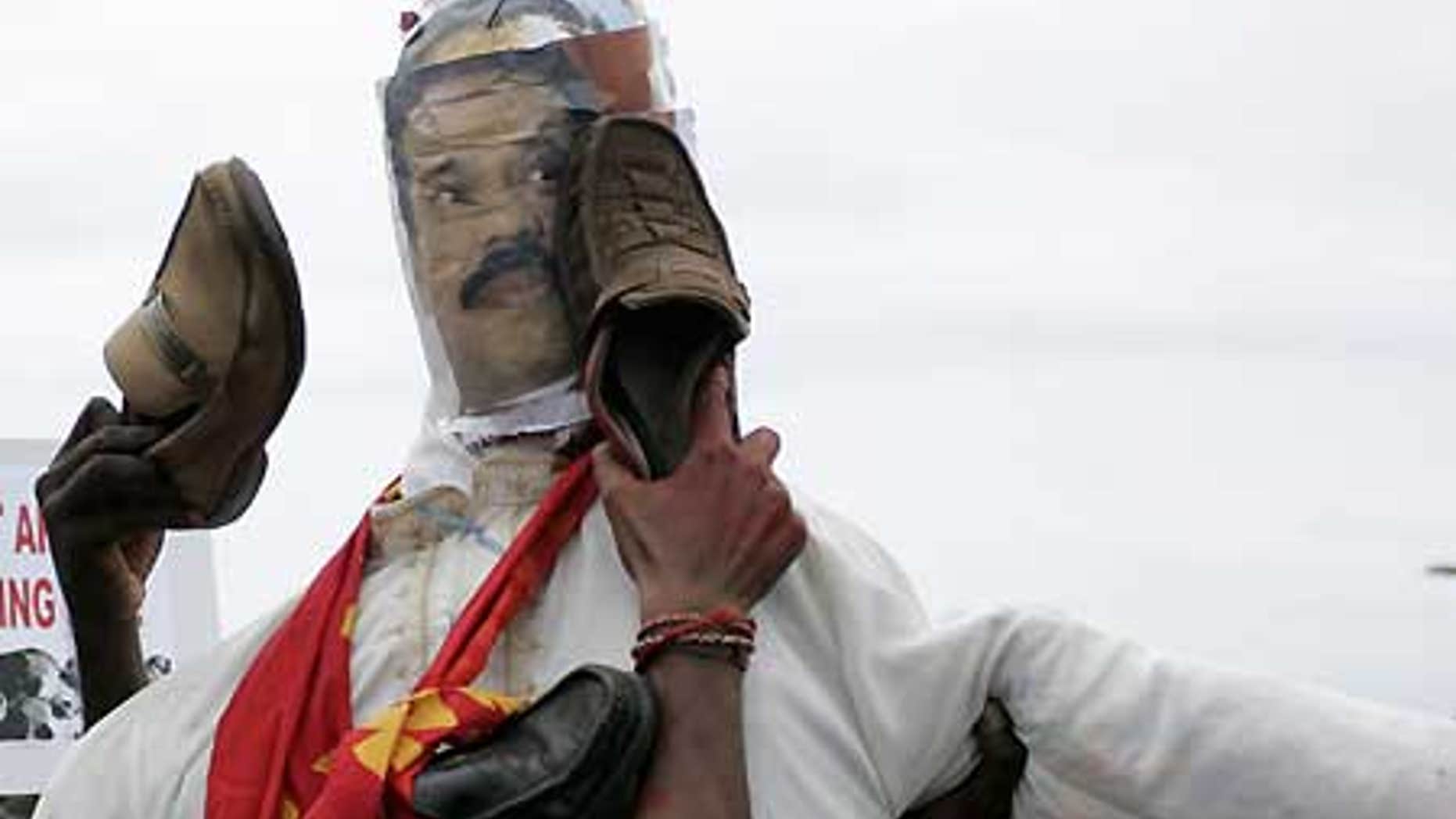 April 21: Malaysian Indian protesters of Tamil ethnicity beat an effigy of Sri Lankan President Mahinda Rajapaksa with shoes.