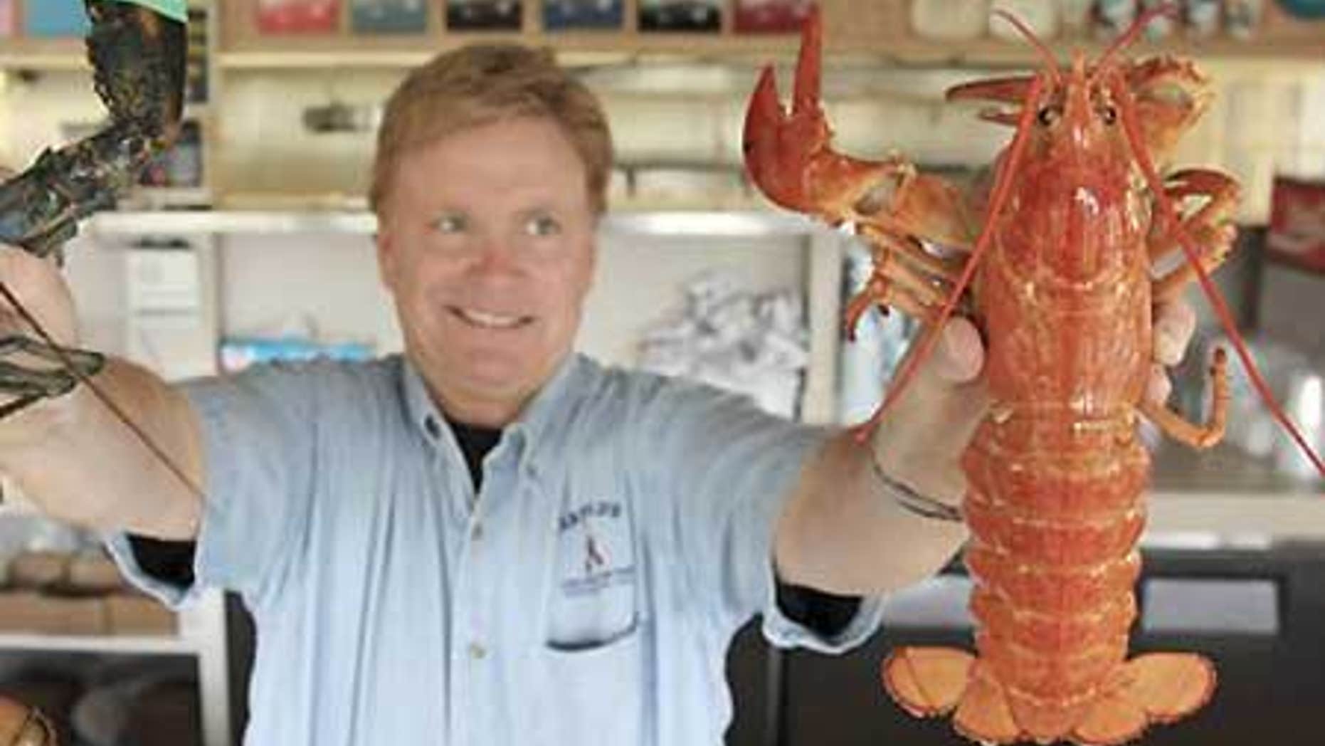 Nathan Nickerson, owner of Arnold's Lobster and Clam Bar, holds up a rare "yellow lobster."