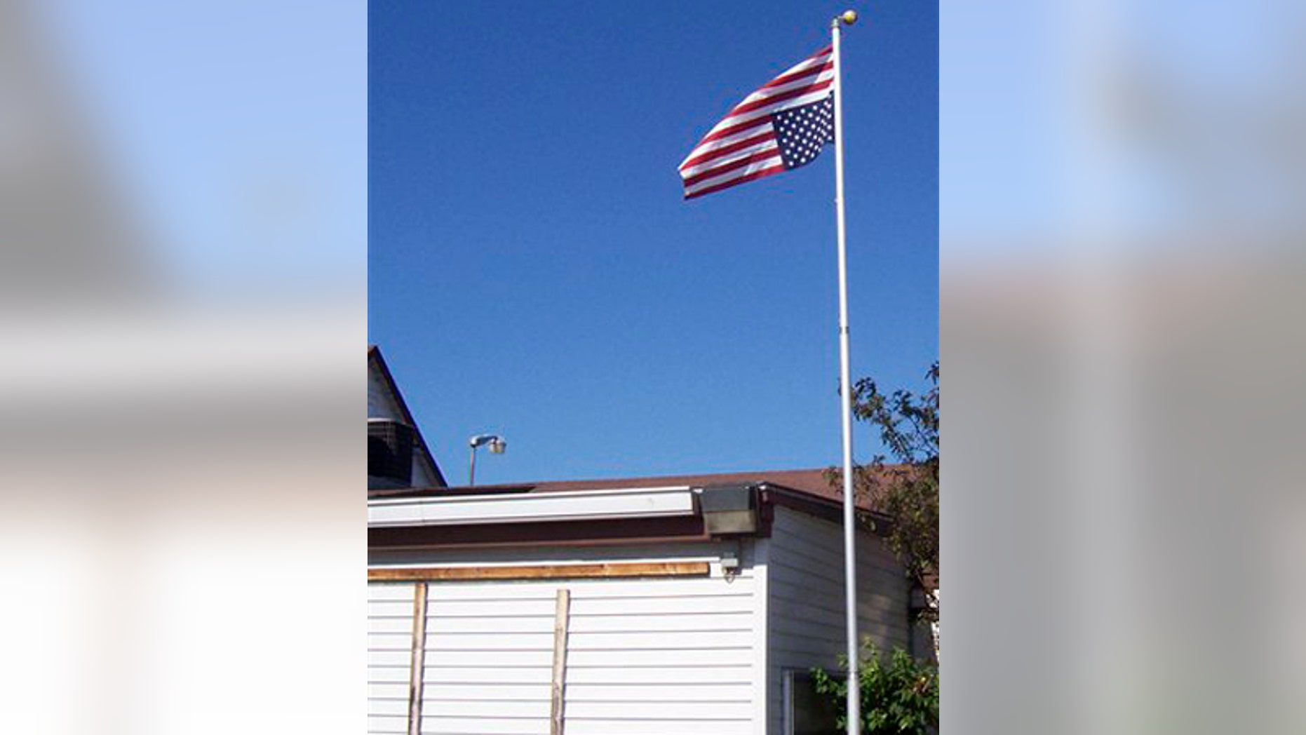 July 5, 2009: American flag being flown upside down, a day after it was removed by local police, in Crivitz, Wis.