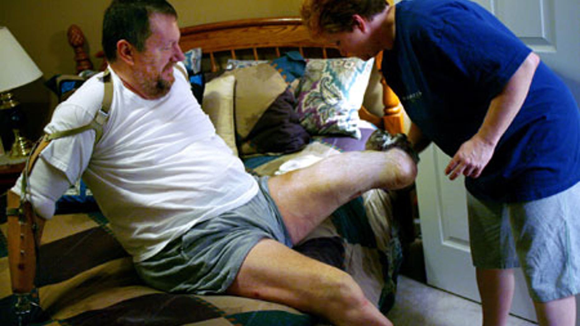 Feb. 4, 2009: Valarie Kepner washes her husband, Jeff Kepner's legs following a shower.