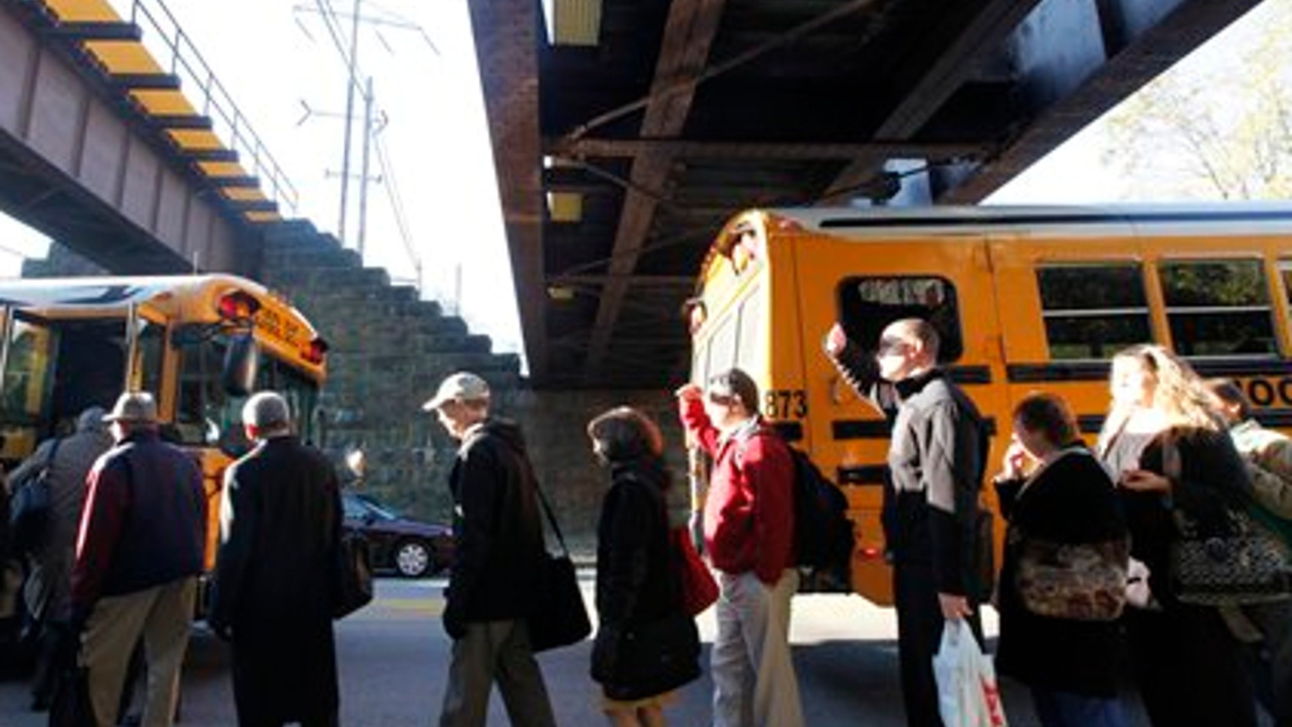 Nov. 4: Stranded commuters are loaded on buses near the scene of a train fire in Philadelphia.