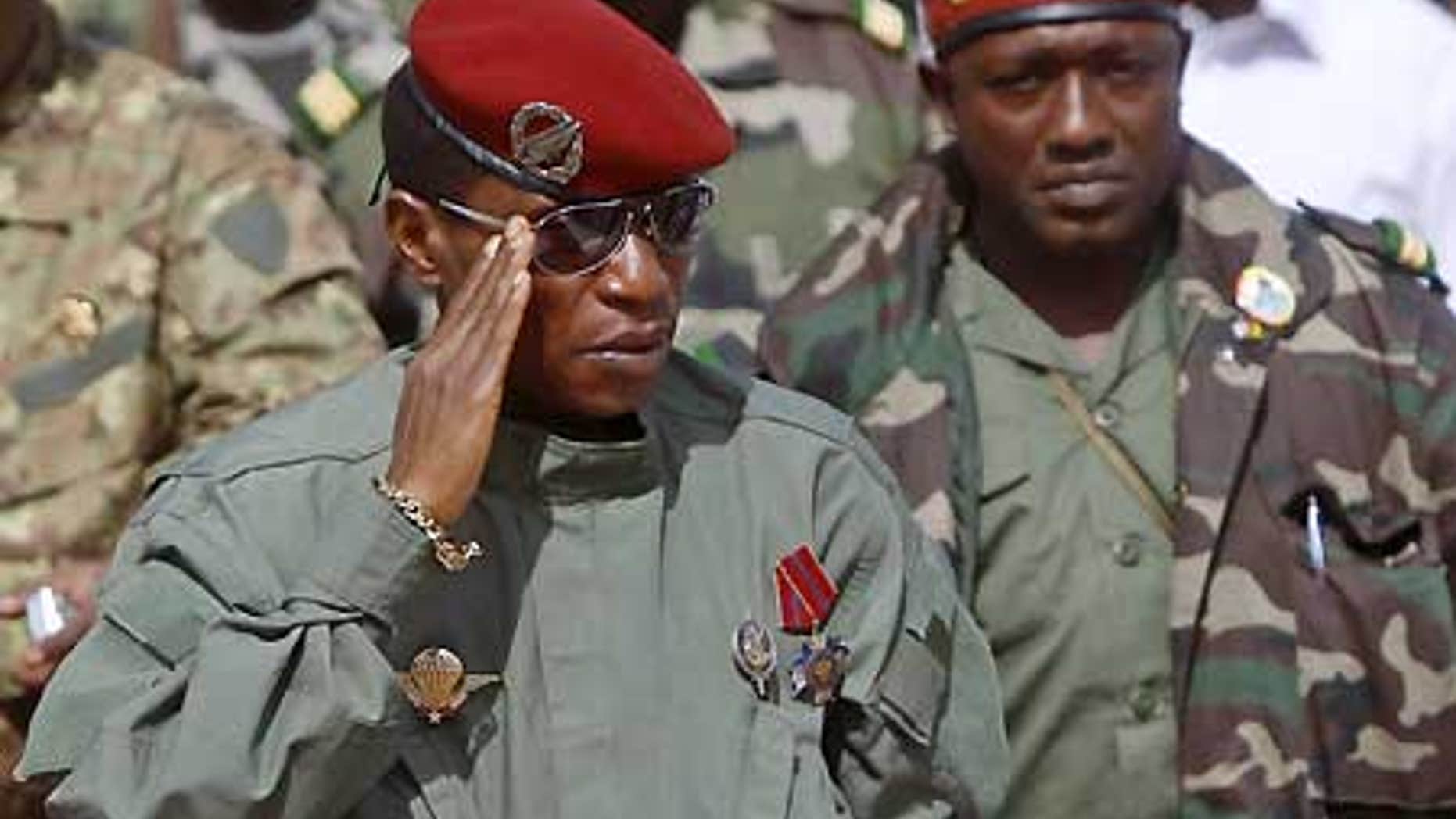 Guinea's military leader, Capt. Moussa "Dadis" Camara, left, salutes next to presidential guard chief Abubakar "Toumba" Diakite, right.