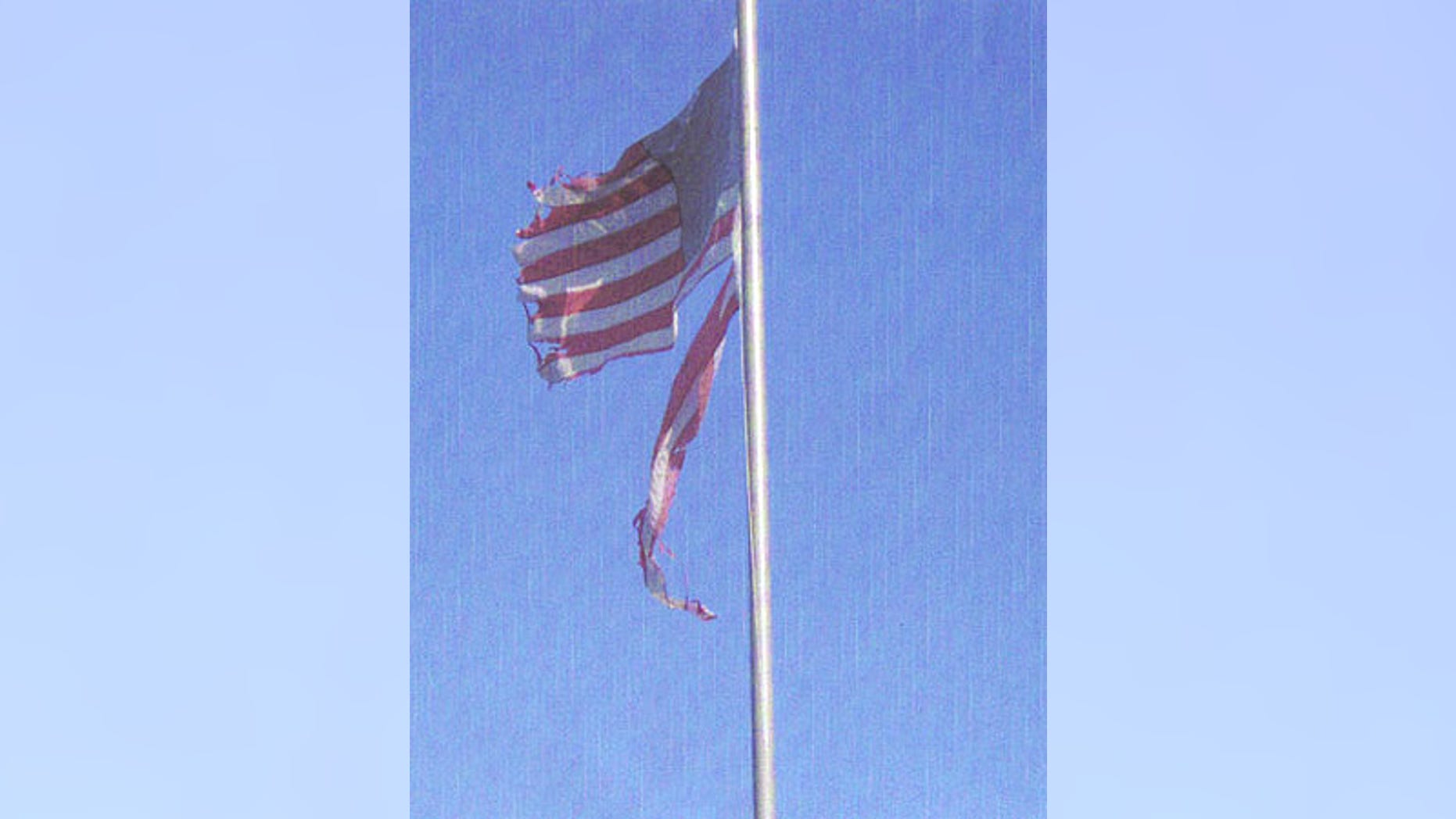 Despite calls by neighbors, this weathered U.S. flag won't come down until Corporal Paul Haros, U.S. Army Reserves, returns to California.