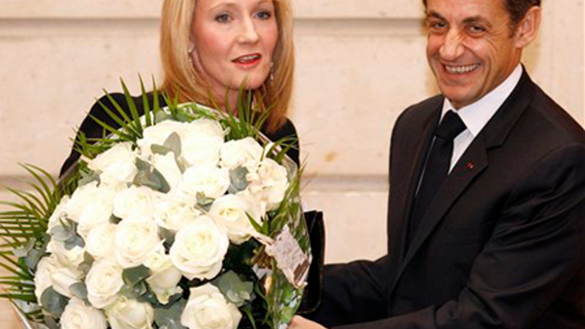 Feb. 3: British writer J.K. Rowling, left, receives a bouquet from French President Nicolas Sarkozy during a ceremony at the Elysee Palace in Paris.
