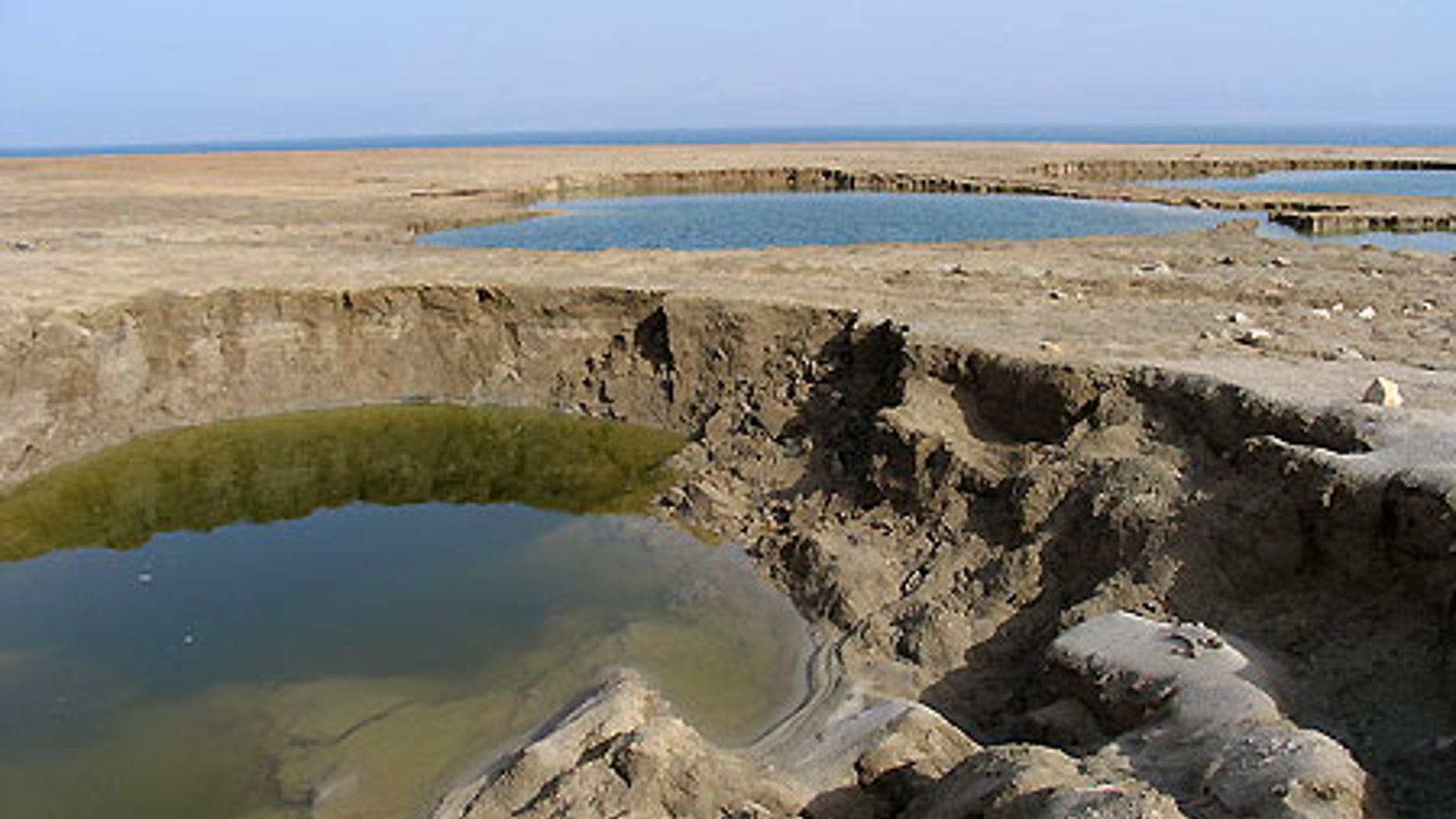 Sinkholes at the Dead Sea's Mineral Beach, in the West Bank, in February 2005.