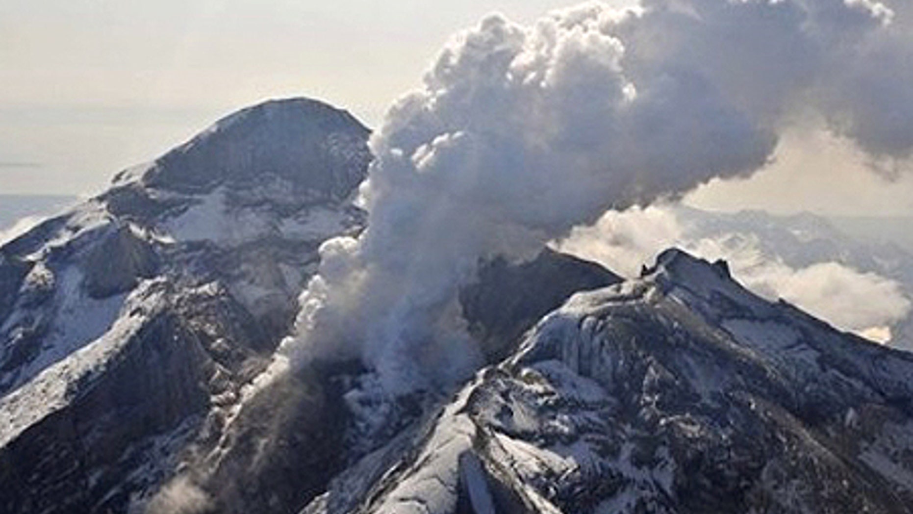 In this May 8, 2009 photo provided by the Alaska Volcano Observatory, the summit crater, active lava dome, and steam plume of the Mount Redoubt volcano, located about 100 miles southwest of Anchorage, are shown. Mount Redoubt hasn't had a major eruptive event in more than a month but scientists say that could soon change. (AP Photo/Alaska Volcano Observatory, USGS, Chris Waythomas)