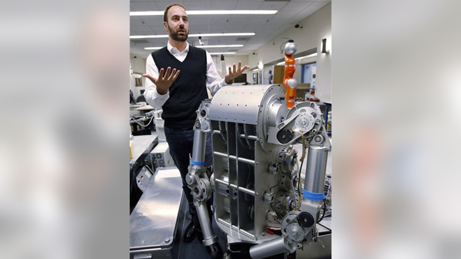 Nov. 24: Ryan Calo stands next to a robot that is being built for medical applications at Stanford University's Artificial Intelligence Laboratory.