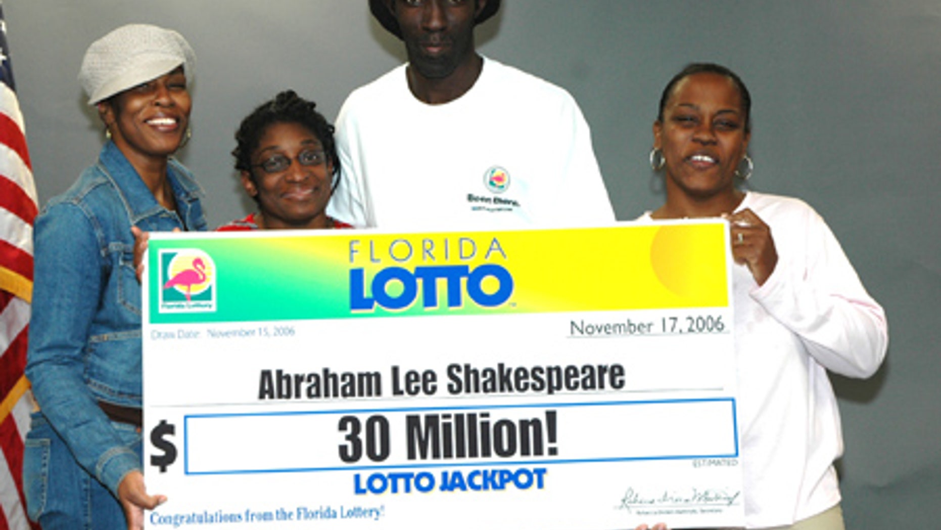 Abraham Shakespeare, center, displays an oversized check after winning the lottery in 2006. The last time anyone saw Shakespeare was in April.