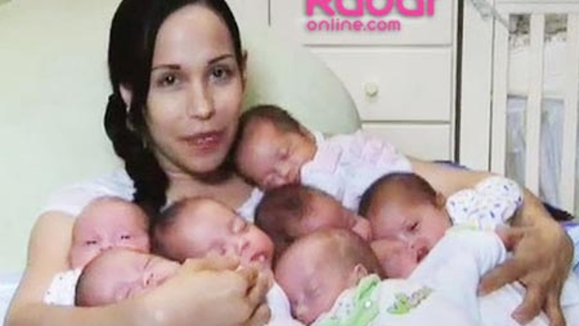 Nadya Suleman poses at home with her octuplets. The last of the octuplets was released from the hospital this week.