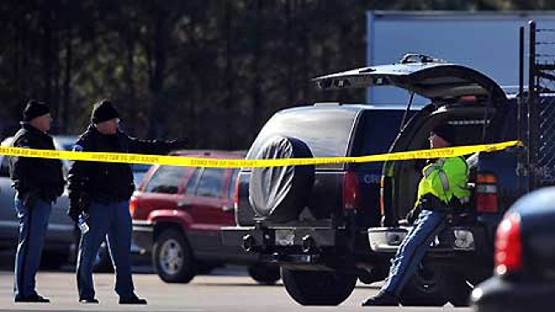 Jan. 12: Police gather after a shooting at Penske Rental in Kennesaw, Ga.
