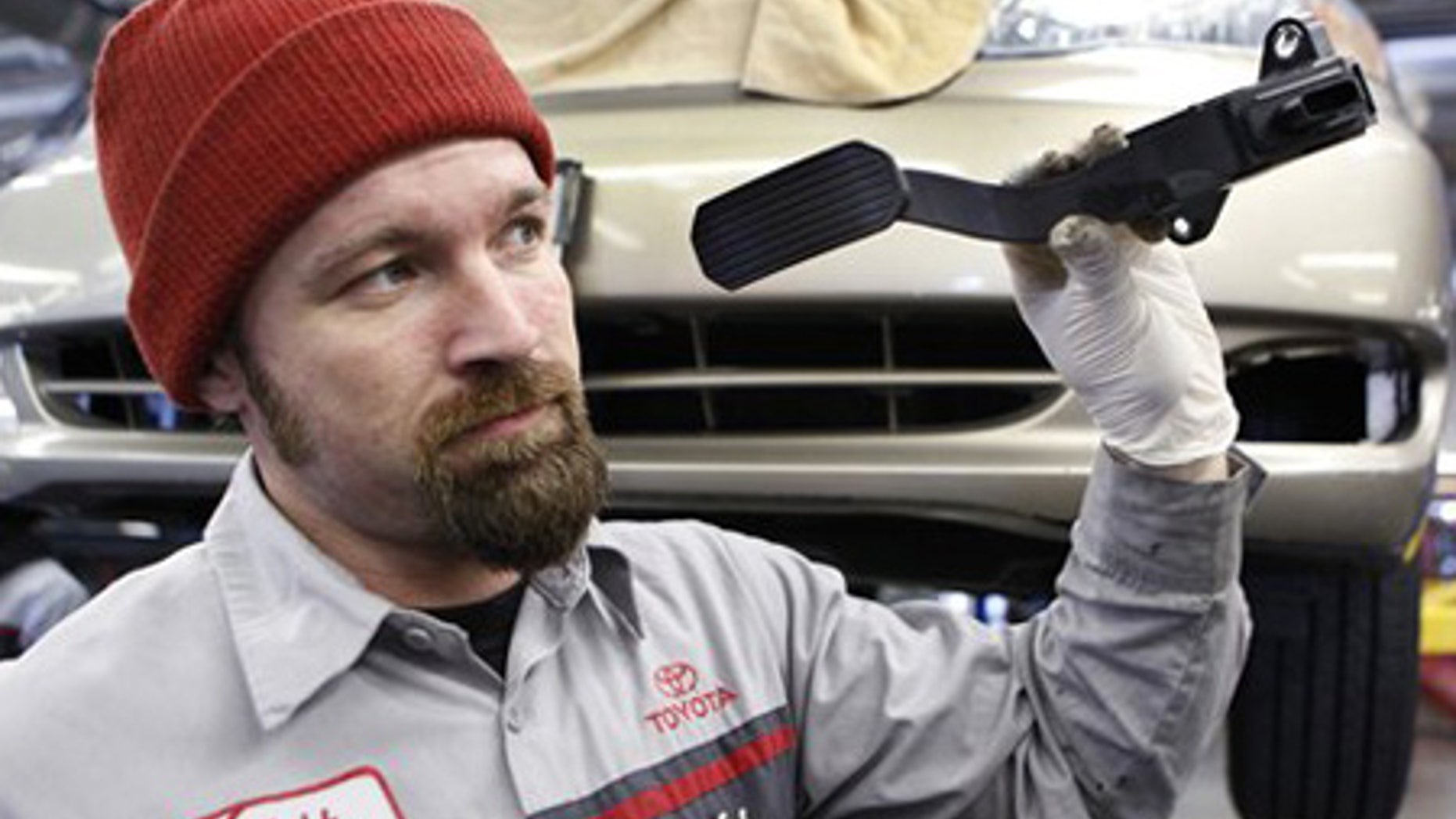 Feb. 3: Mechanic Matthew Lee holds a recalled Toyota gas pedal at a Toyota dealership in Palo Alto, Calif.