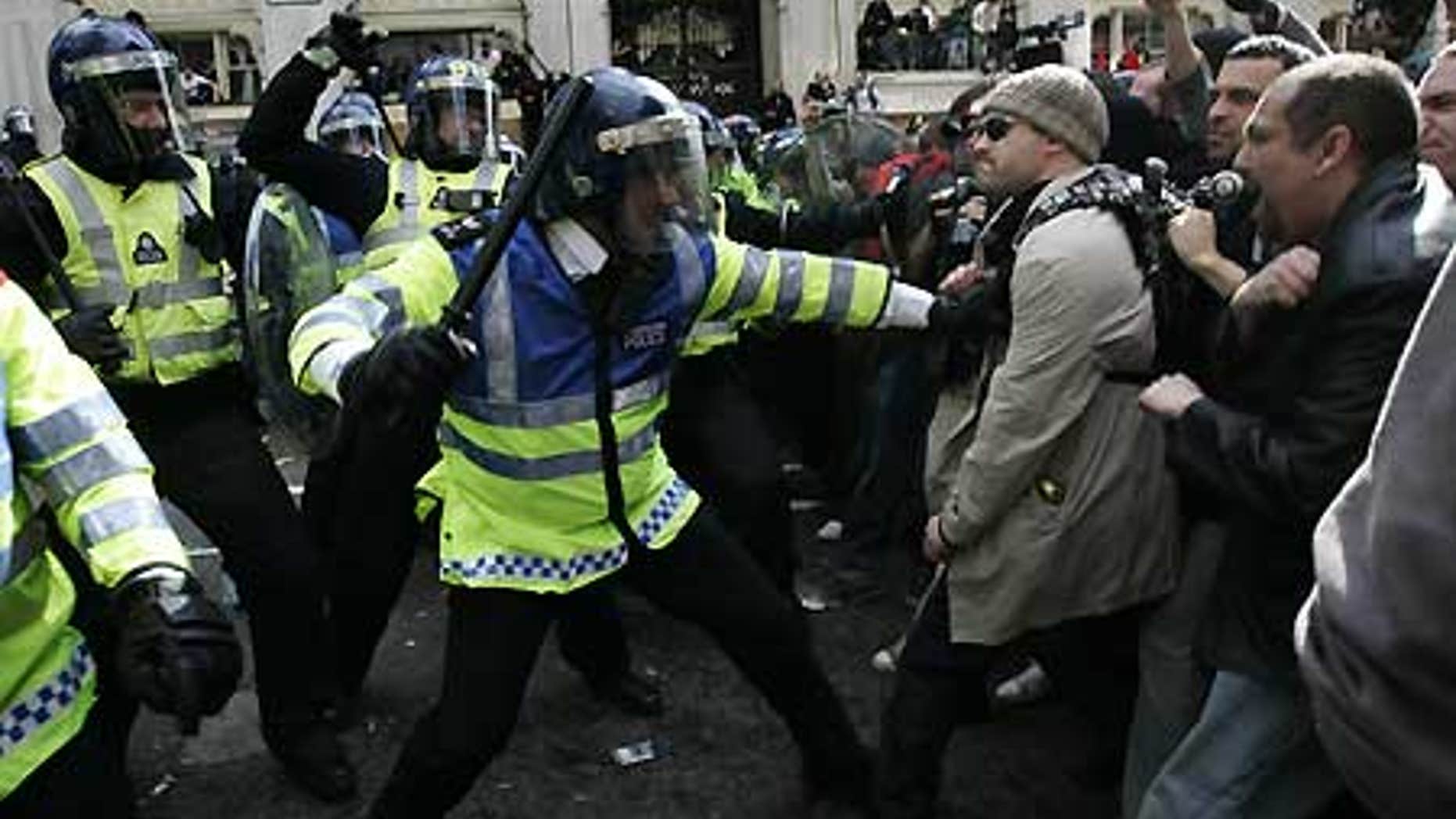 April 1: British police in riot gear, left, and protesters are seen during clashes in central London's financial district.