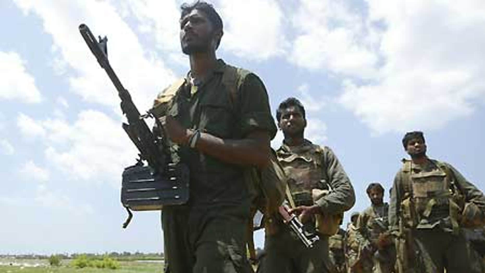 April 24: Sri Lankan soldiers patrol near the war zone in Puthukudiyiruppu, about 150 miles northeast of Colombo, Sri Lanka.