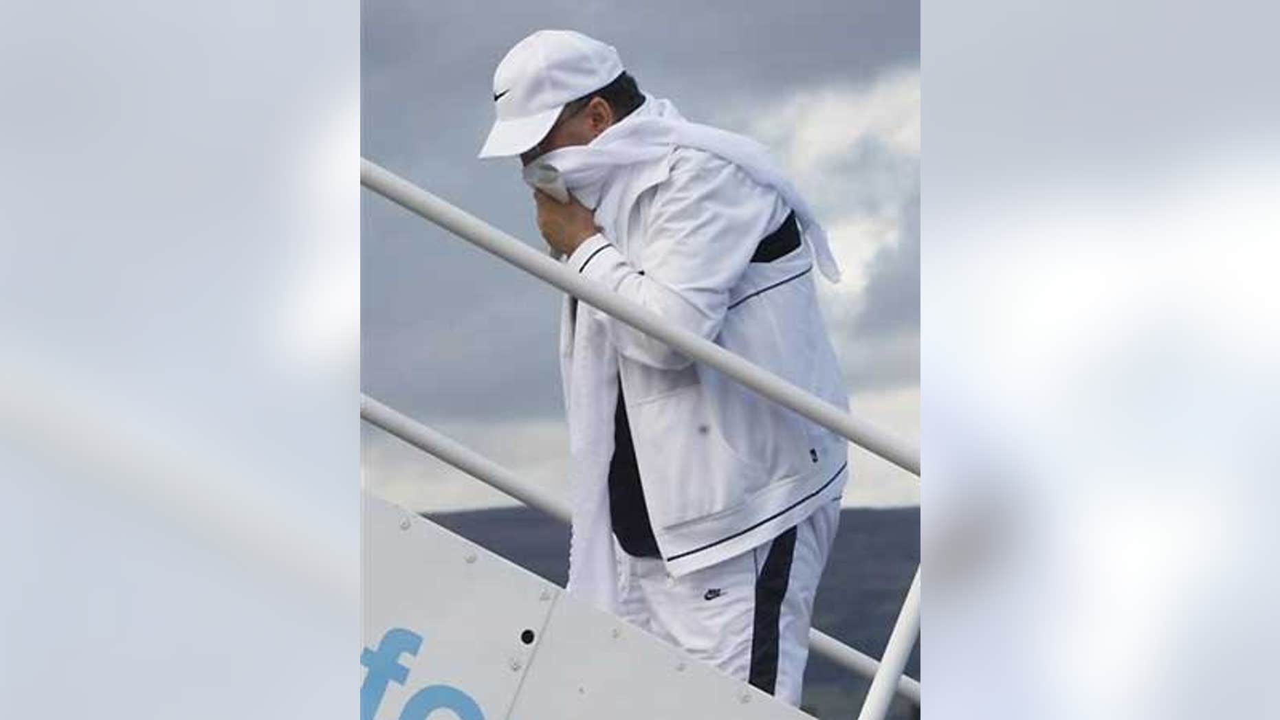 Aug 20: Lockerbie bomber Abdel Baset al-Megrahi holds his prisoner release papers as he walks up stairs to board an airplane in Scotland.