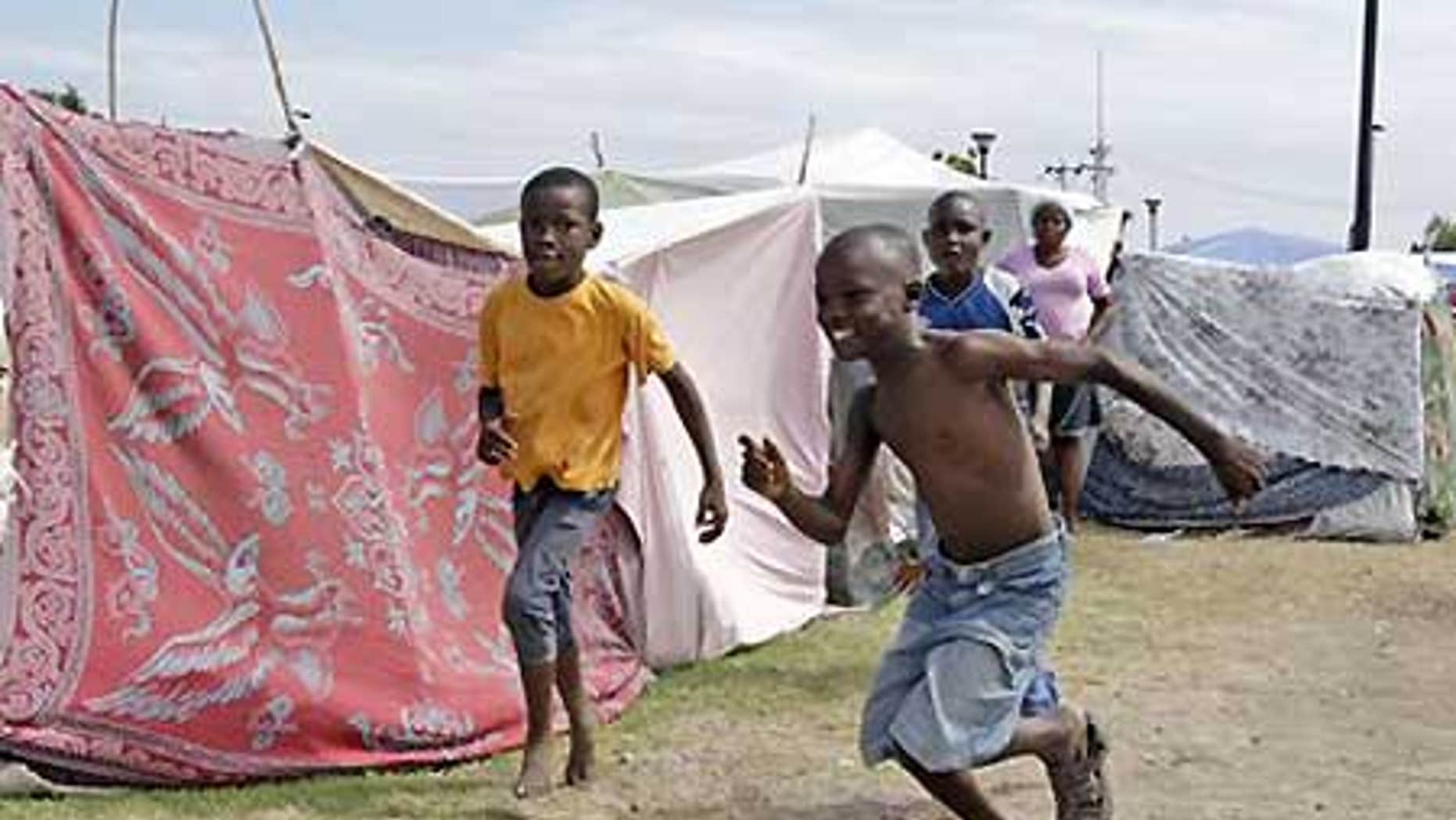 Jan. 26: Boys play in a tent city called Mais Gate near Port au Prince airport.