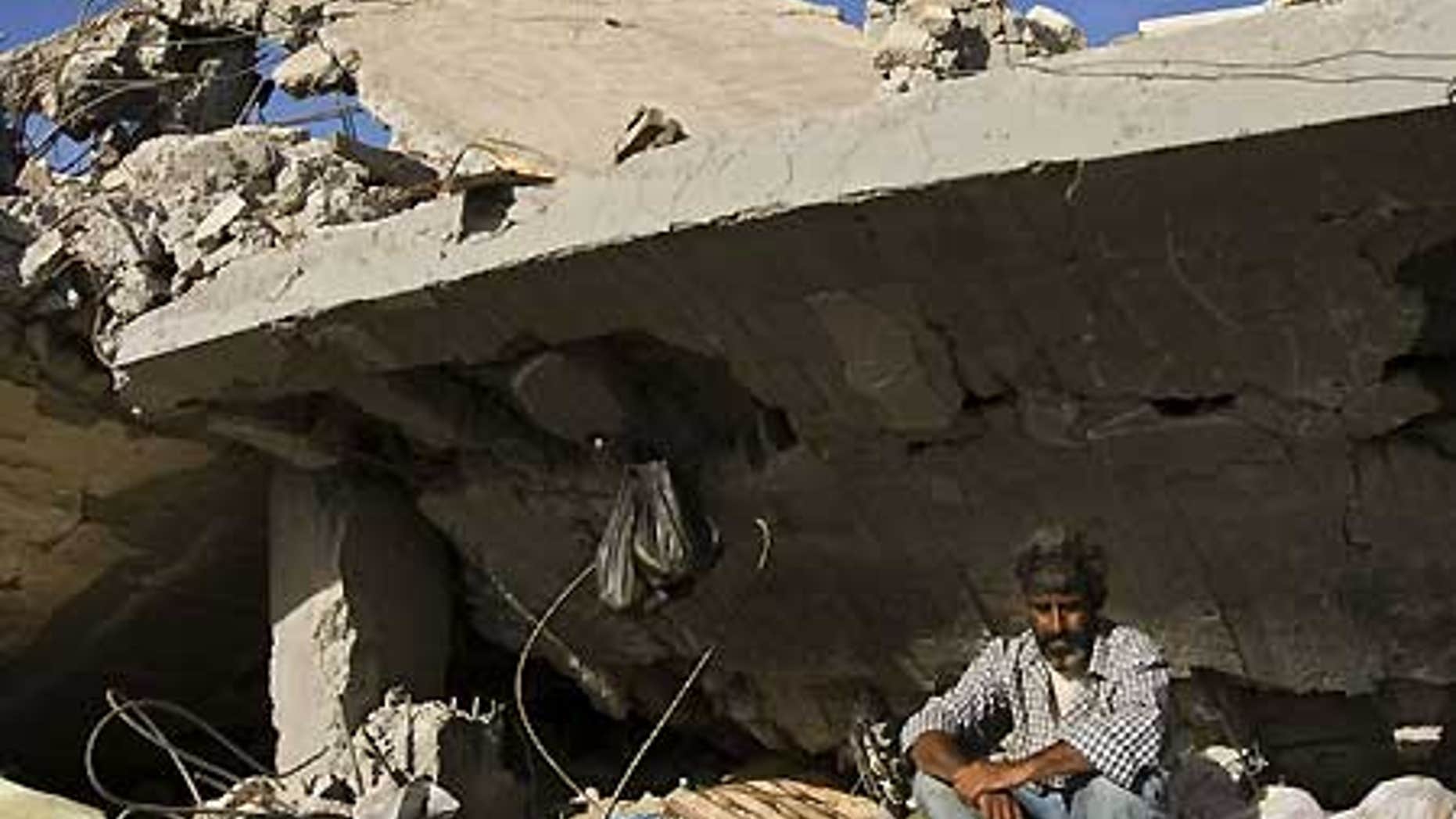 Feb. 3: A Palestinian man sits in the rubble of his destroyed house, in an area that was hit in the last Israeli military offensive in the Gaza Strip.