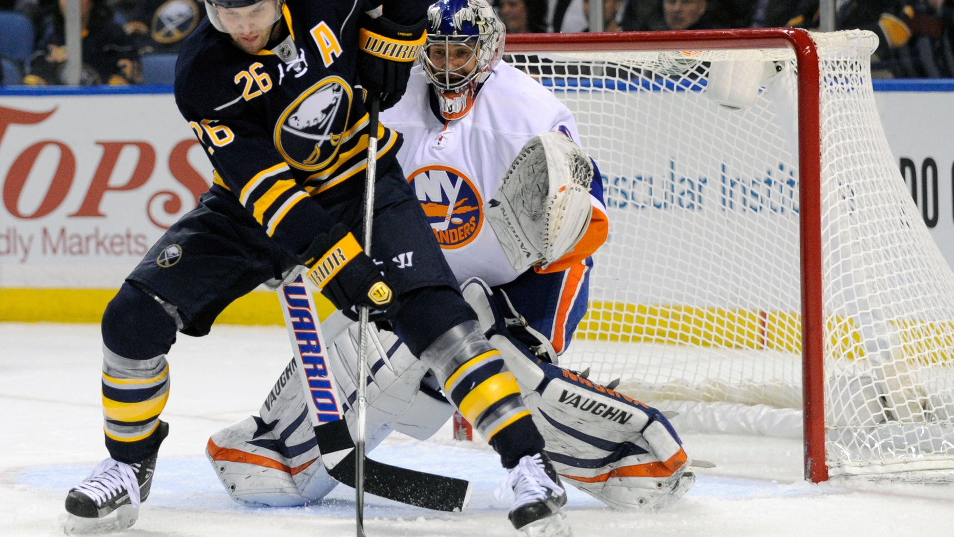 File- This Feb. 23, 2013 file photo shows Buffalo Sabres' left winger Thomas Vanek (26), of Austria, getting ready to deflect the puck in front of New York Islanders' goaltender Evgeni Nabokov (20), of Russia, during the first period of an NHL hockey game in Buffalo, N.Y., The New York Islanders announced Sunday Oct. 27, 2013, that they have acquired Vanek from the Buffalo Sabres in exchange for Matt Moulson, a first round selection in the 2014 NHL draft and a second round selection in 2015. (AP Photo/Gary Wiepert, File)