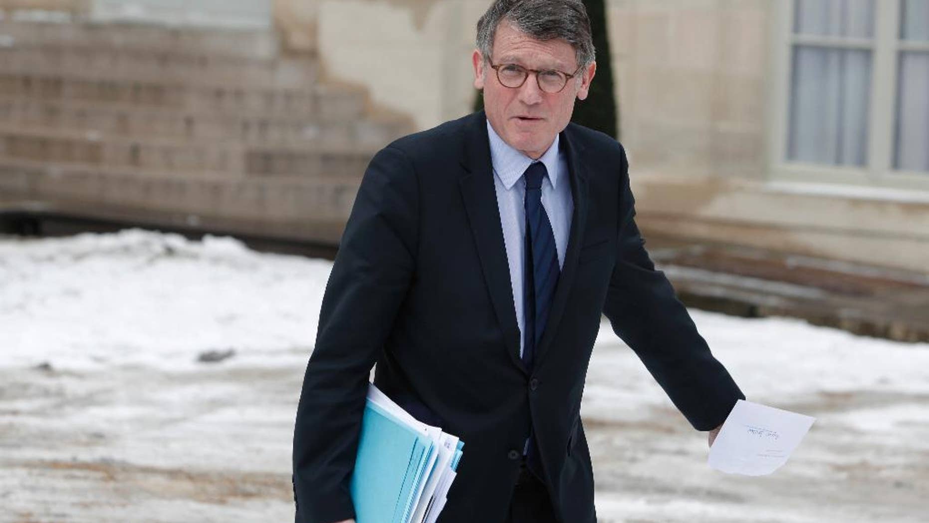 FILE - In this March 13, 2013 file photo, then French Education Minister Vincent Peillon leaves the Elysee Palace after the weekly cabinet meeting, in Paris. Candidates in the leftist primary Jan 22 and 29 Manuel Valls and Vincent Peillon laid out their platforms Tuesday Jan. 3, 2017, pleading for unity and tolerance in the face of far right candidate Marine Le Pen's anti-immigration, anti-EU campaign.(AP Photo/Thibault Camus, File)