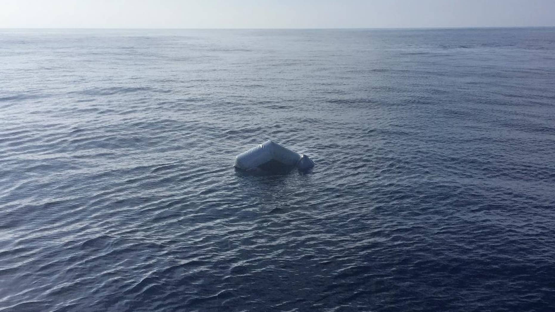 In this photo released by Proactiva Open Arms NGO on Friday, March 24, 2017 an upturned rubber boat floats in the Mediterranean Sea off the Libyan coast, during a search and rescue operation by Spanish NGO Proactiva Open Arms. A Spanish aid organization says it fears hundreds of migrants may have died off the coast of Libya after five bodies were found near two capsized boats and the search for a third vessel reported missing had so far proved futile. (Proactiva Open Arms via AP)