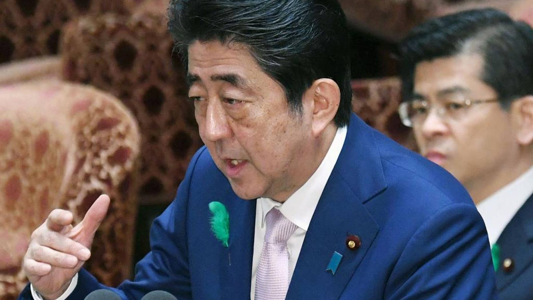 Japanese Prime Minister Shinzo Abe speaks during an Audit and Oversight of Administration Committee session at the lower house of Parliament in Tokyo Monday, April 17, 2017. Abe said Monday that Japan's government is drawing up contingency plans in case a crisis on the Korean Peninsula sends an influx of refugees to Japan. Abe told a parliamentary session that the government is formulating measures including protecting foreigners, landing procedures, building and operating shelters, and screening asylum seekers. (Yoshinobu Shimizu/Kyodo News via AP)