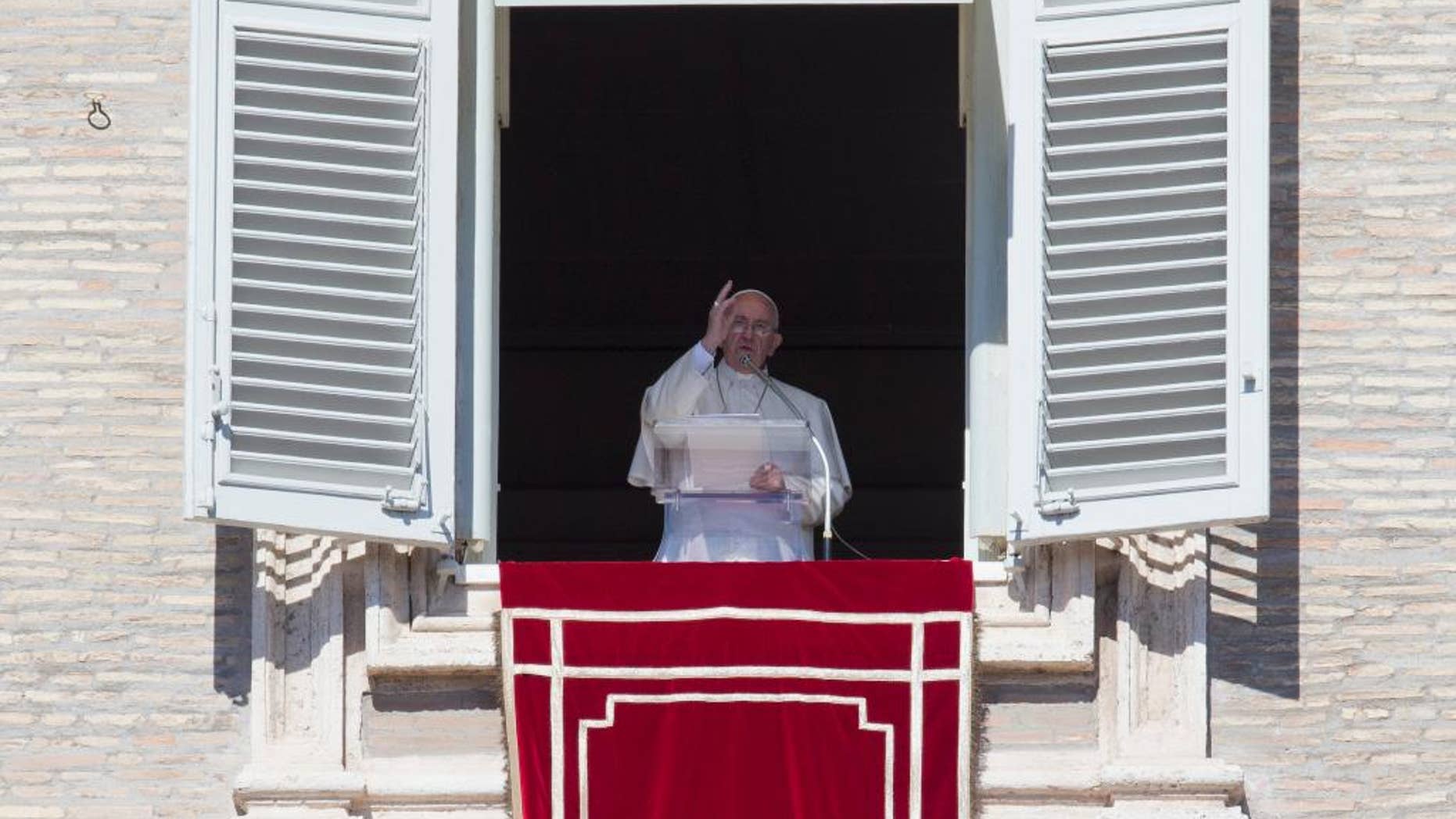 Pope Francis delivers his blessing during the Angelus noon prayer he celebrated from the window of his studio overlooking St. Peter's Square, at the Vatican, Sunday, Oct. 11, 2015. (AP Photo/Andrew Medichini)