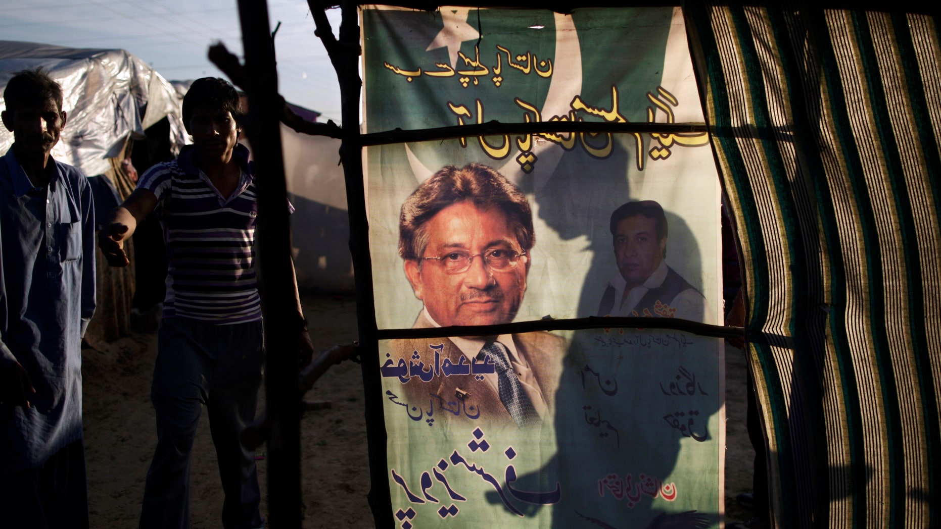 An election banner showing Pakistan's former president and military ruler Pervez Musharraf, is used as a curtain on a makeshift home in a Christian slum on the outskirts of Islamabad, Pakistan, Wednesday, April 17, 2013. Musharraf appeared in court to seek bail in Benazir Bhutto's assassination case. Pakistan's Supreme Court ordered Musharraf to respond to allegations that he committed treason while in power, and barred him from leaving the country only weeks after he returned. (AP Photo/Muhammed Muheisen)